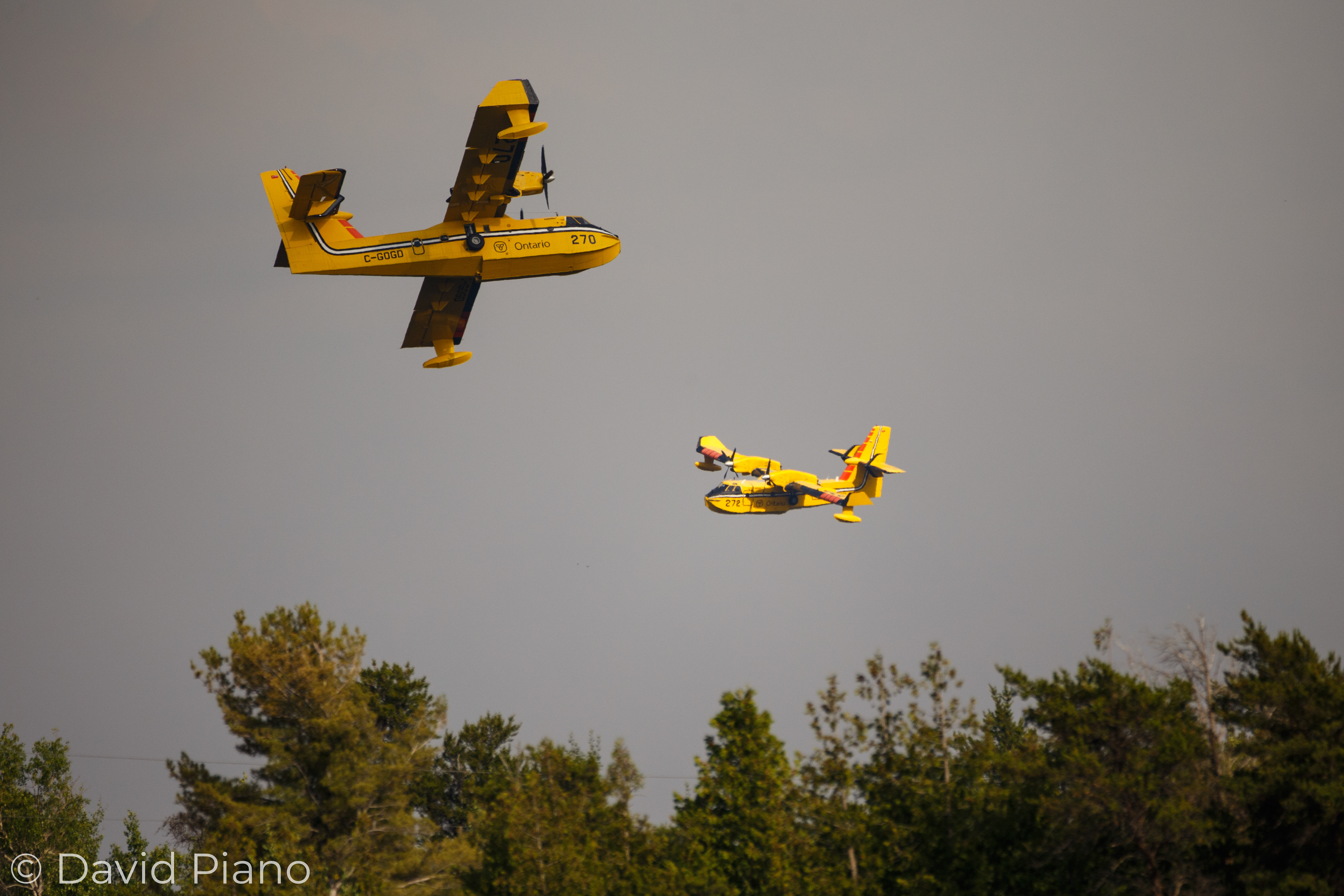 Two CL-415 water-bombers working in tandem to fight the Parry Sound 33 forest fire at Key Harbour - 07/21/2018