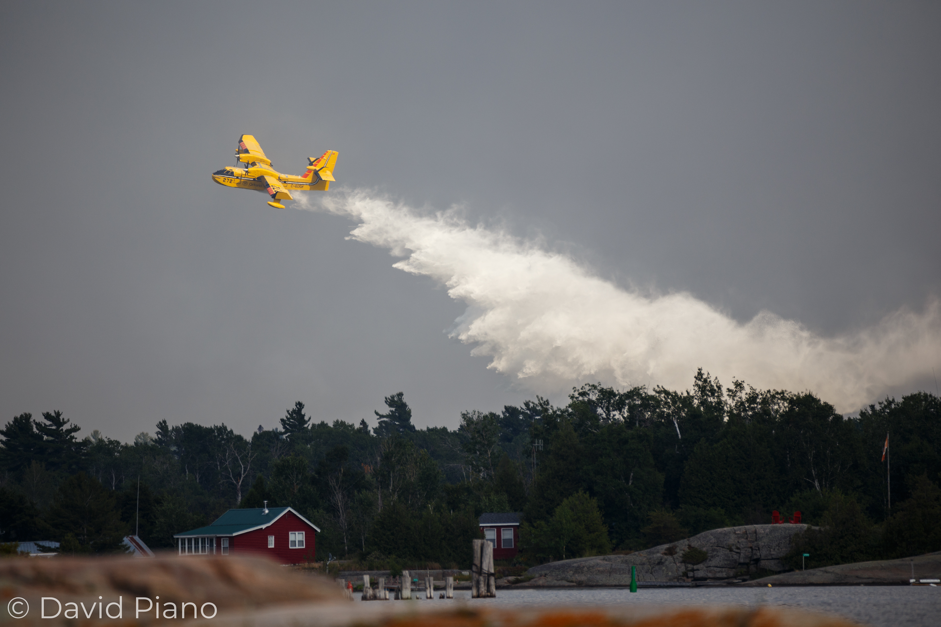 A CL-415 water-bomber drops a full tank on the Parry Sound 33 blaze - 07/21/2018