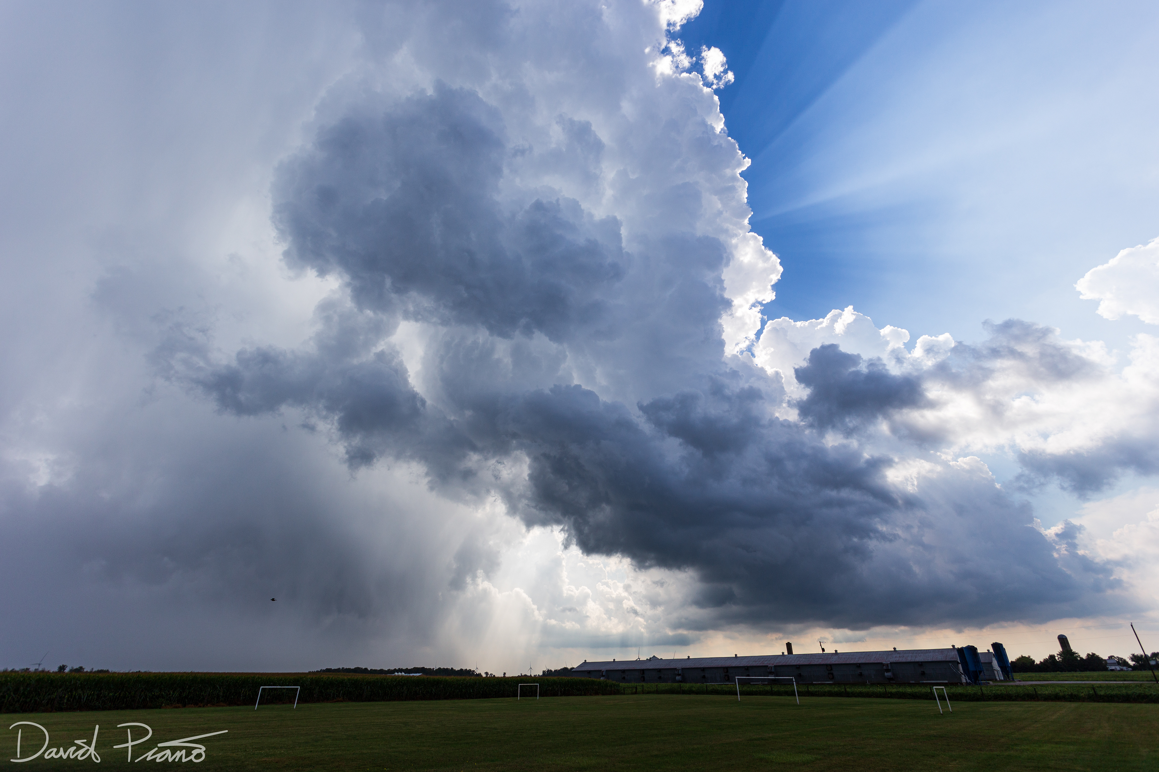 Crepuscular rays fan out from behind a towering CB near Strathroy