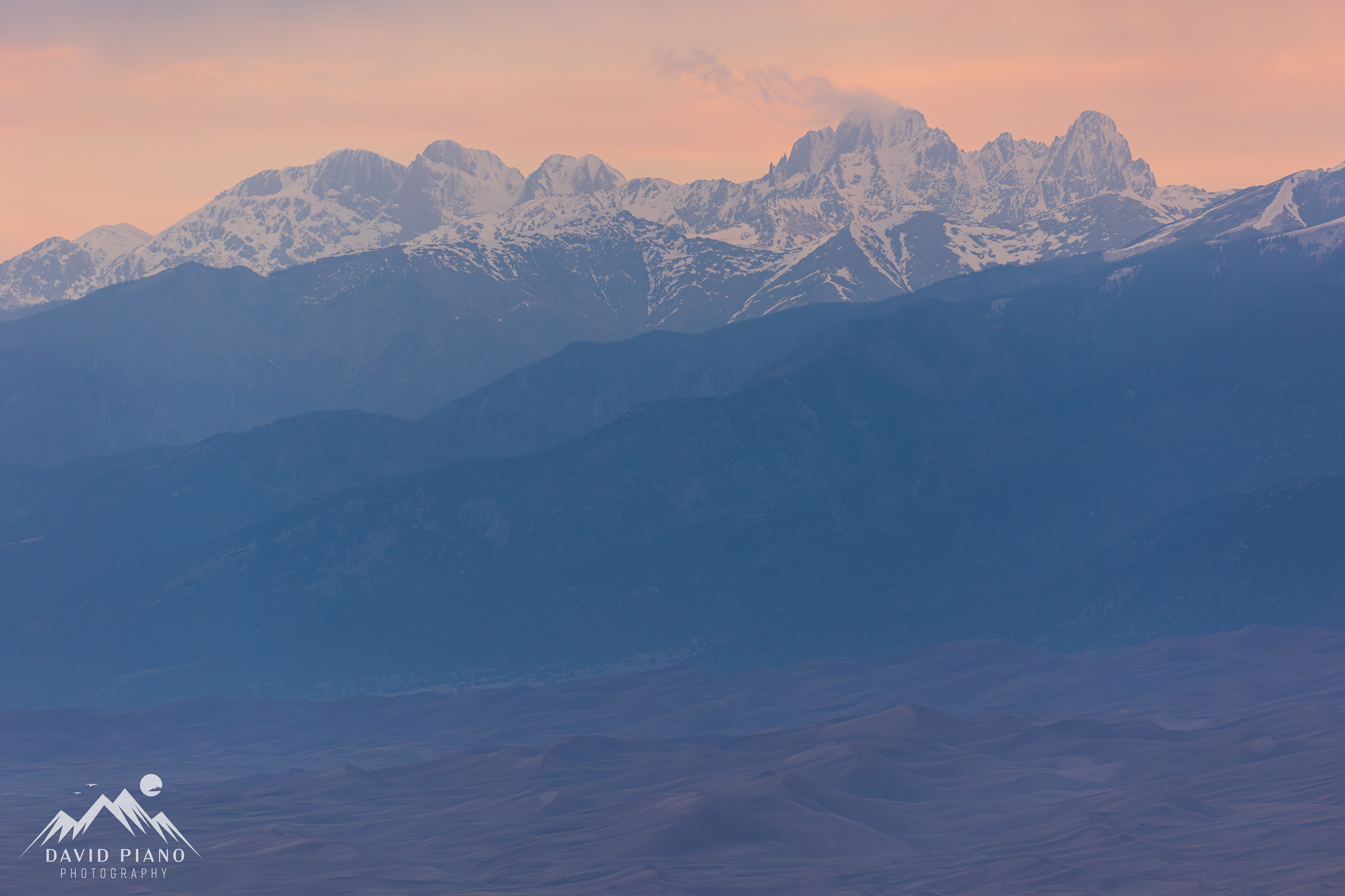 Sangre de Cristo Mountains at sunset with the Great Sand Dunes below
