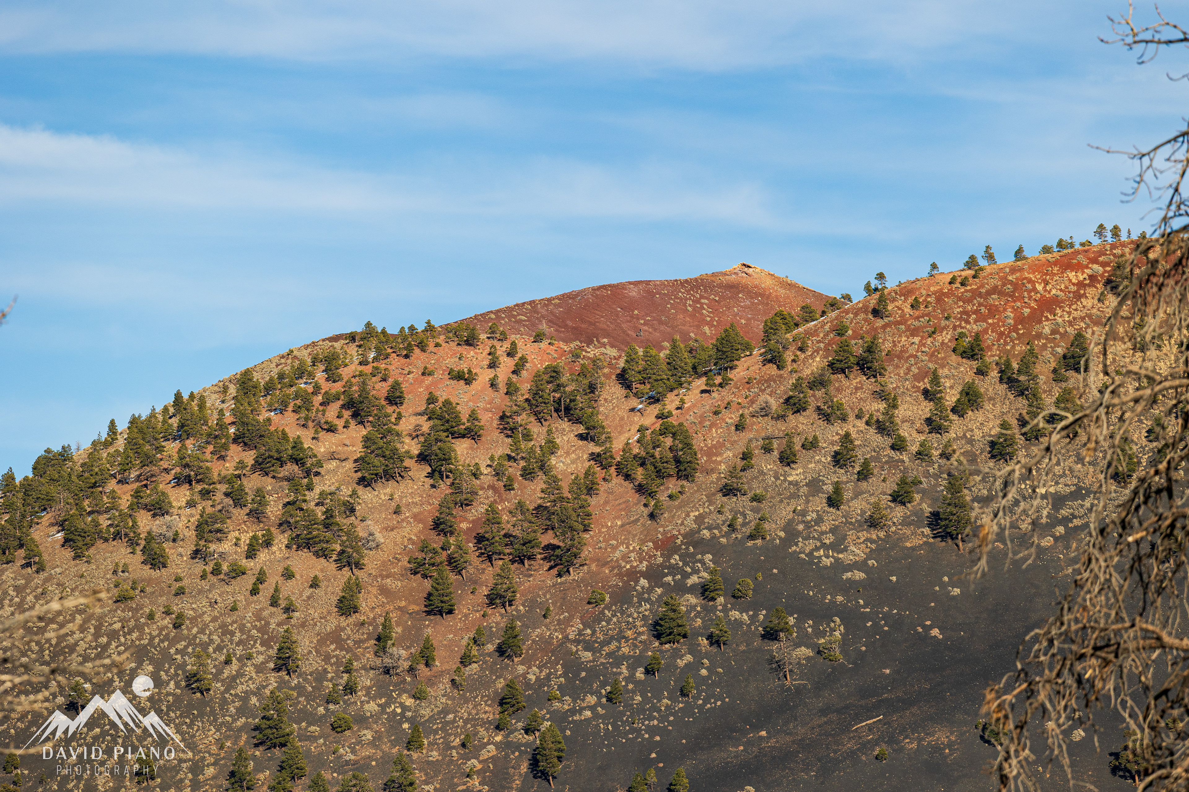 Sunset Crater Volcano gets its name from the rusty hues seen around the crater rim