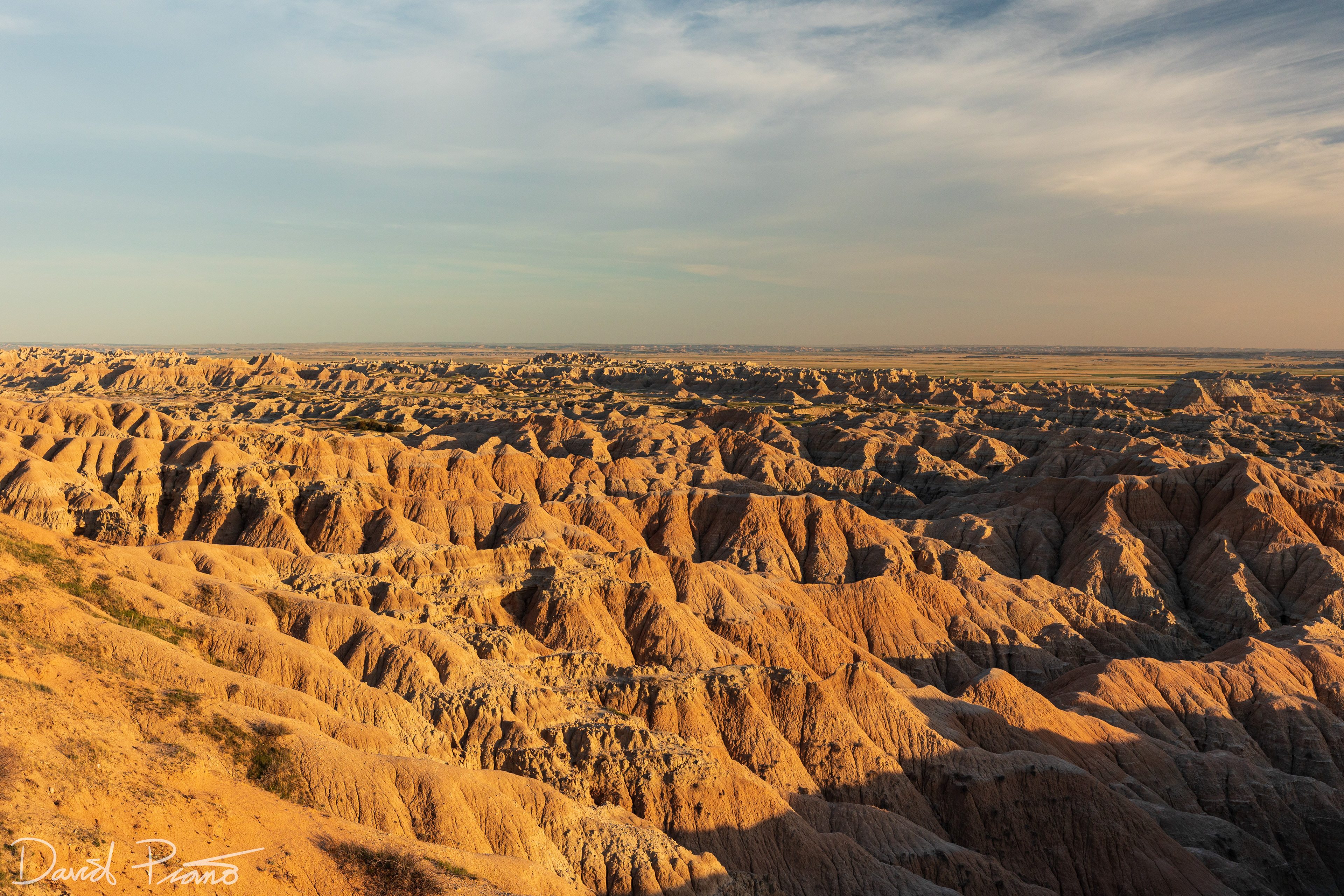 The late day sun adds contrast to the stunning badlands landscape
