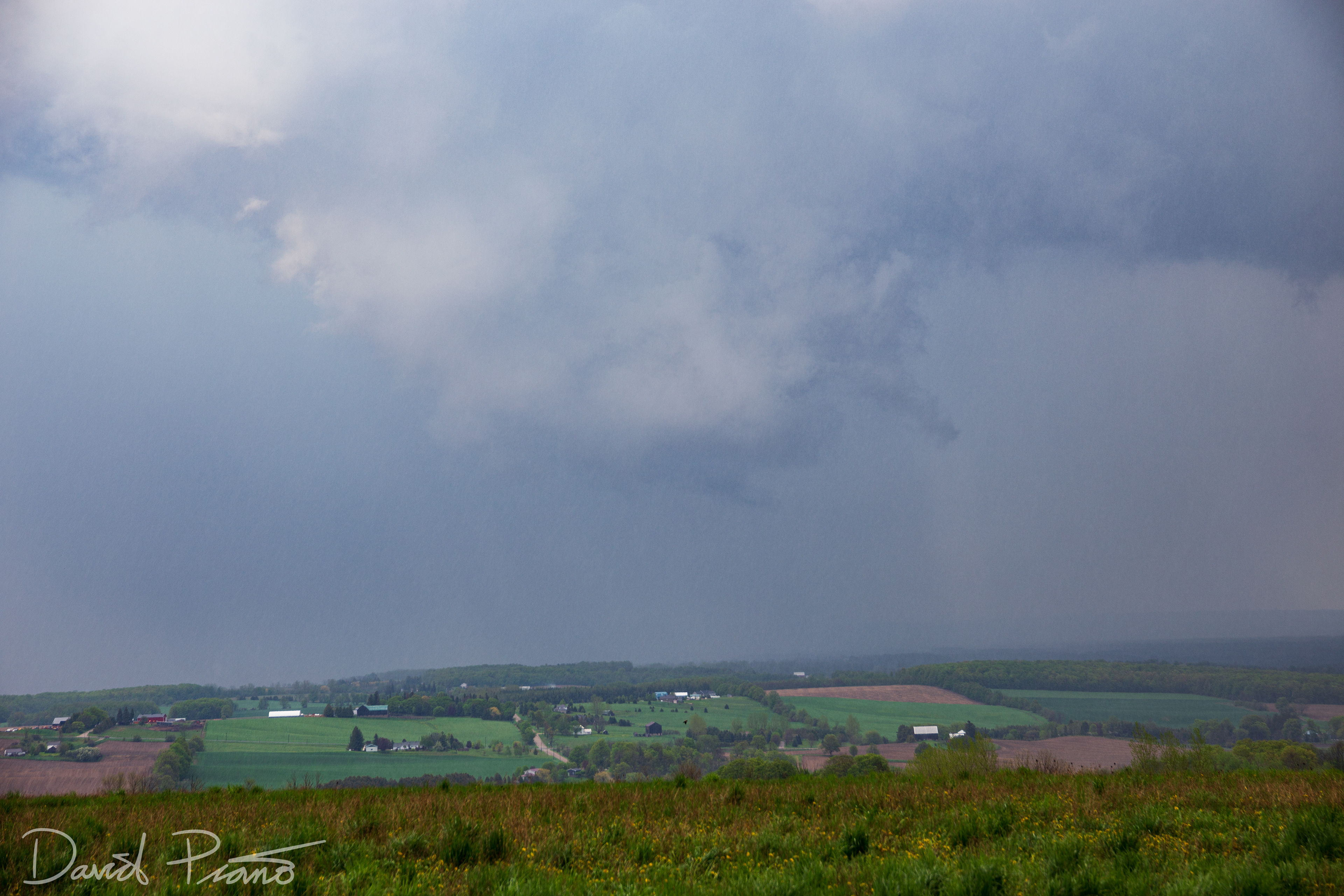 A wall cloud associated with a supercell is seen over Simcoe County from near Creemore - May 24