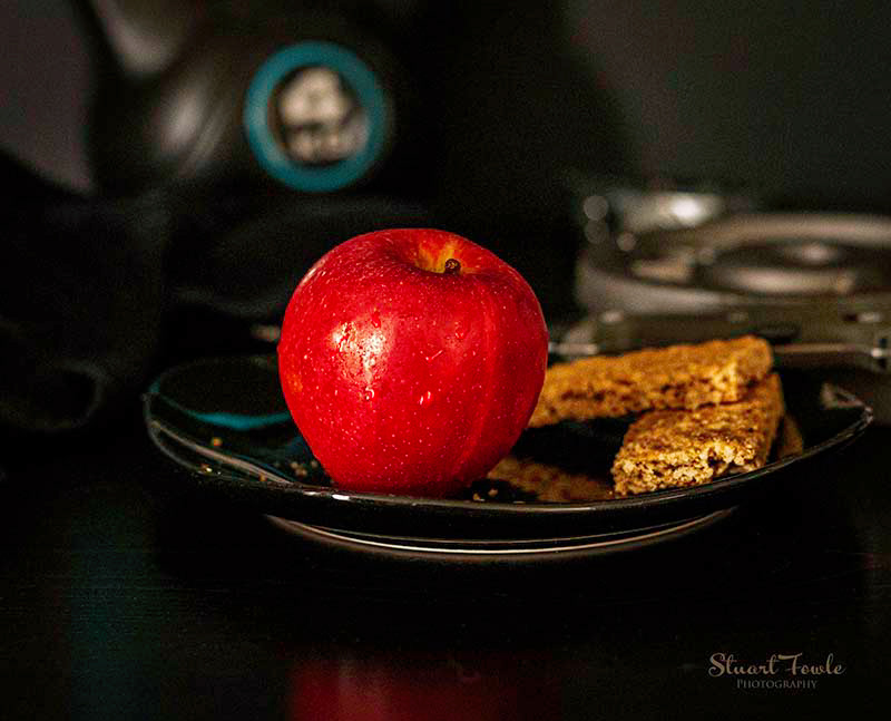 Granola bars with apple and assorted fitness weights.