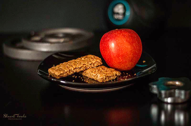 Granola bars with apple and assorted fitness weights.