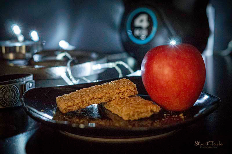 Granola bars with apple and assorted fitness weights.