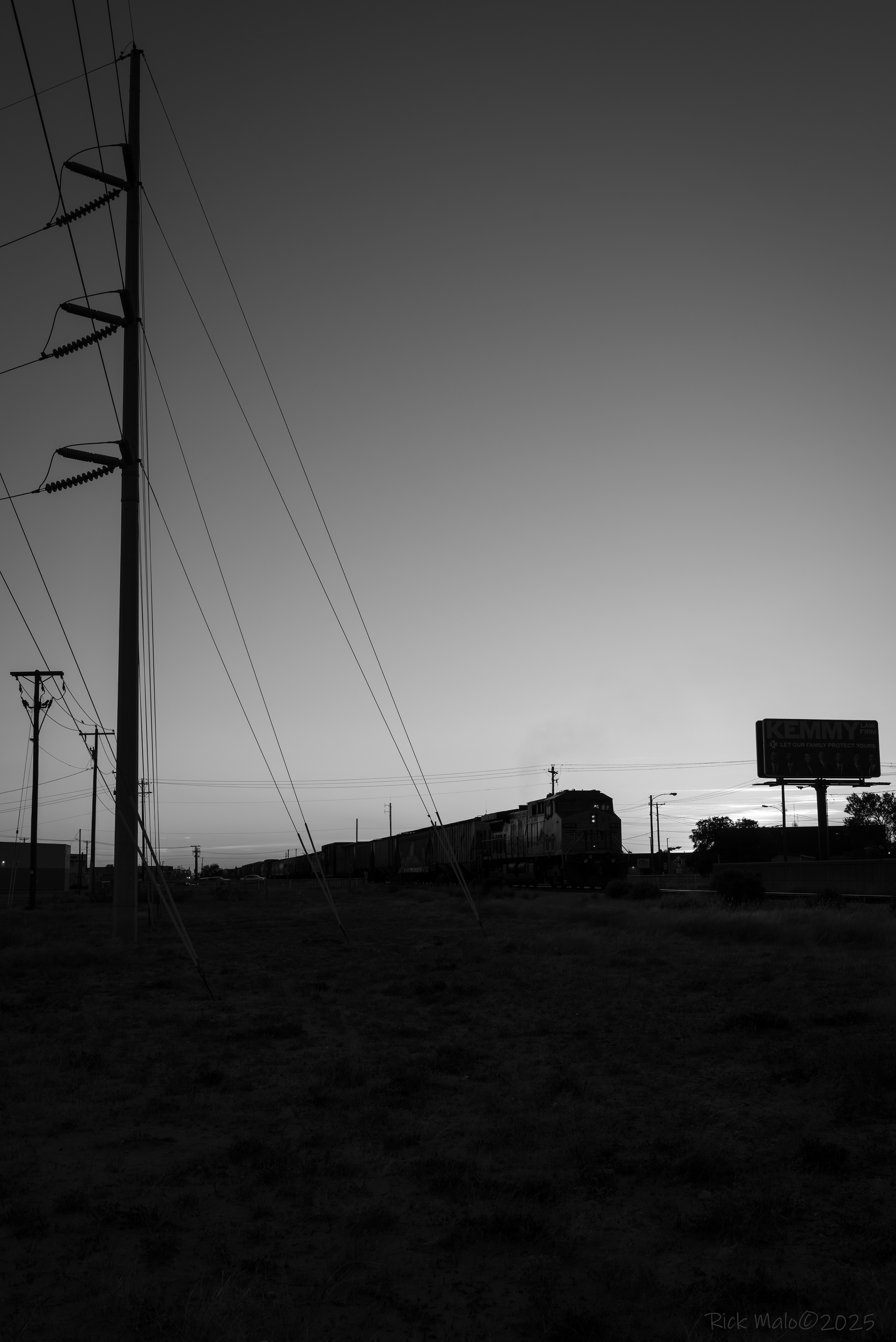 The DPU of a westbound freight rolls through Midland, Texas at dusk.