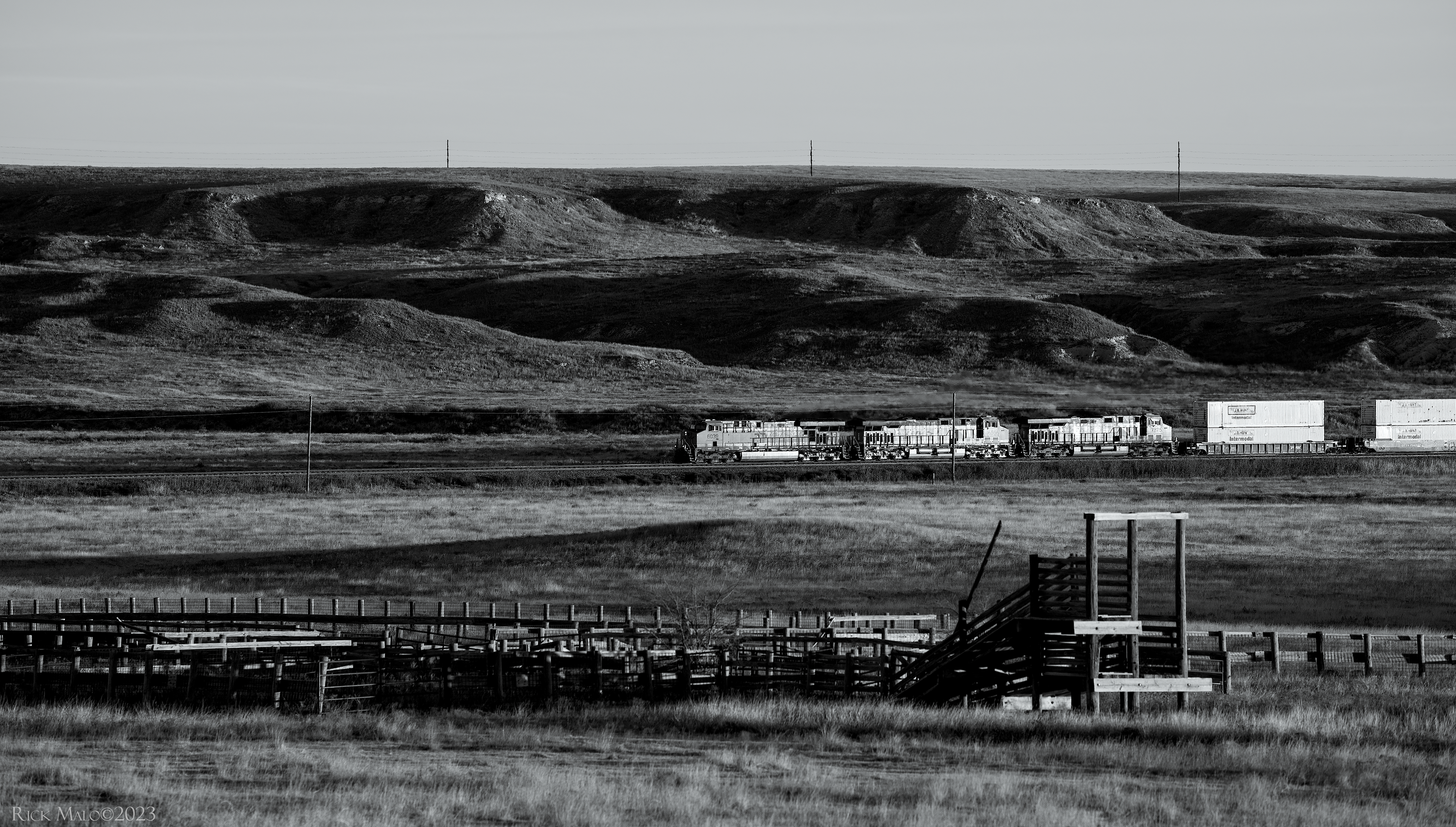 Early on a chilly November 2023 morning, a westbound JB Hunt intermodal train rumbles below the bluffs of the Llano Estacado as it makes its way west through the Red Deer Creek Valley near Miami, Texas.