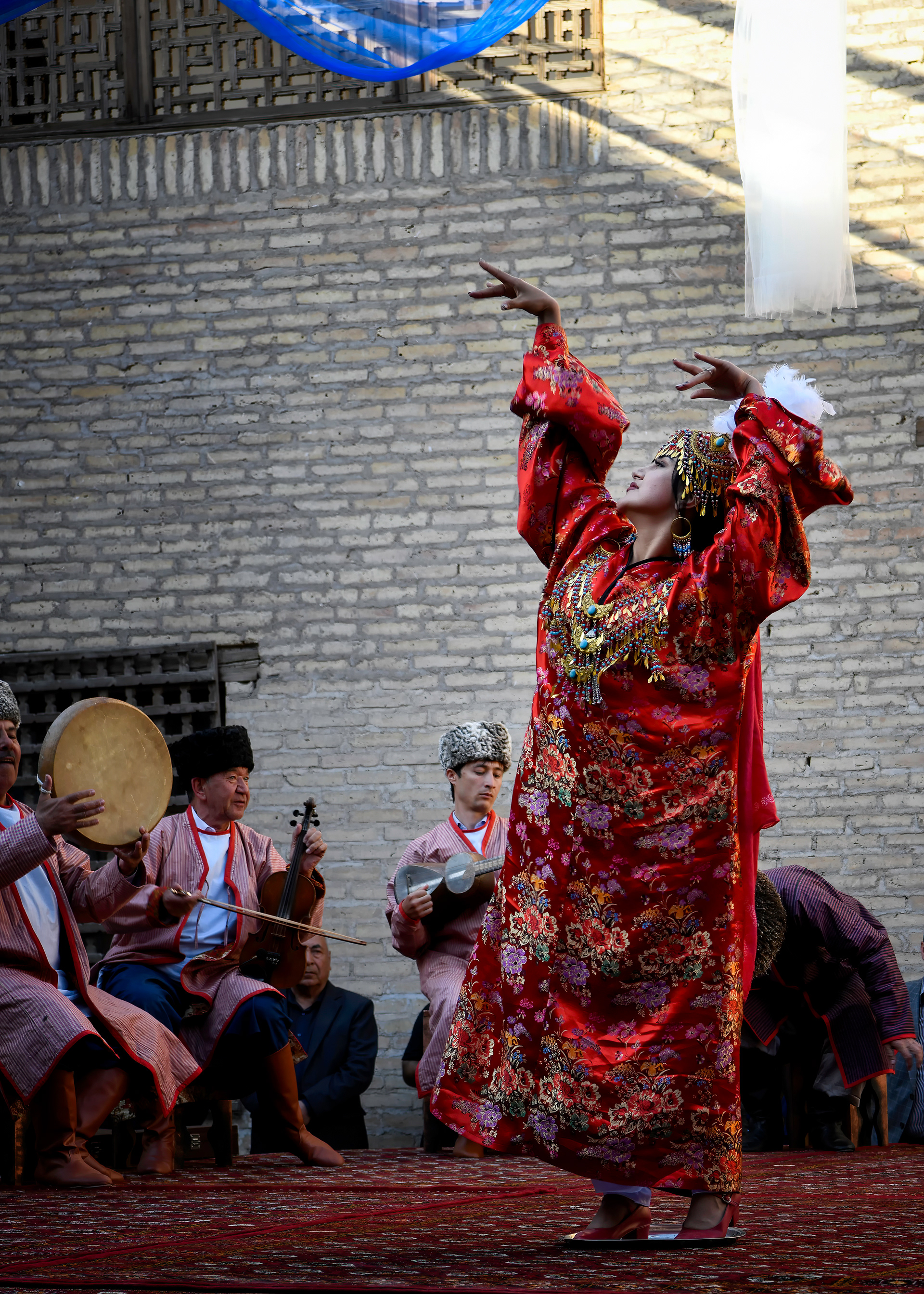 The legend behind Lazgi says it started when a soul, newly poured into clay, was too frightened to move — until it heard a melody from heaven, and the fingers came alive first, then the wrists, then the whole body followed. That's supposedly why the dance still starts exactly like that: hands and wrists waking up before anything else joins in, then building until it's over almost as abruptly as it started. UNESCO didn't add it to the world heritage list until December of that year — eight months after this was taken.