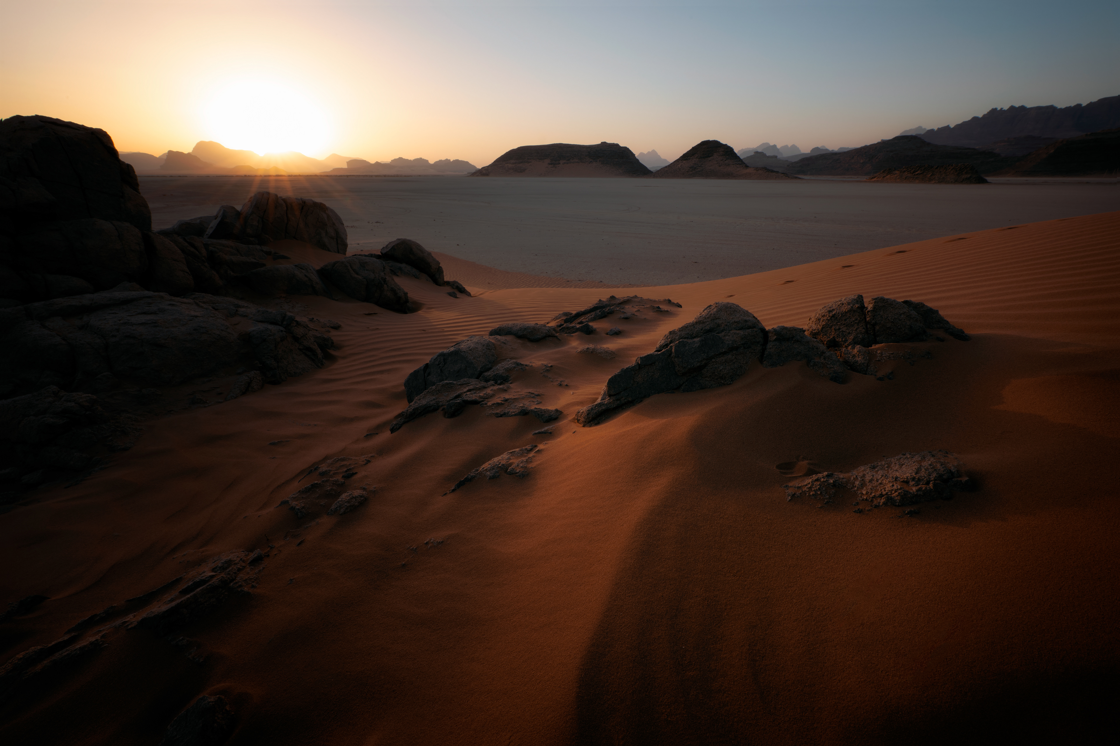 Dune with sun flare — Wadi Rum. A long wait in the sand for the sun to break the horizon, until the light finally turned warm across the dune.