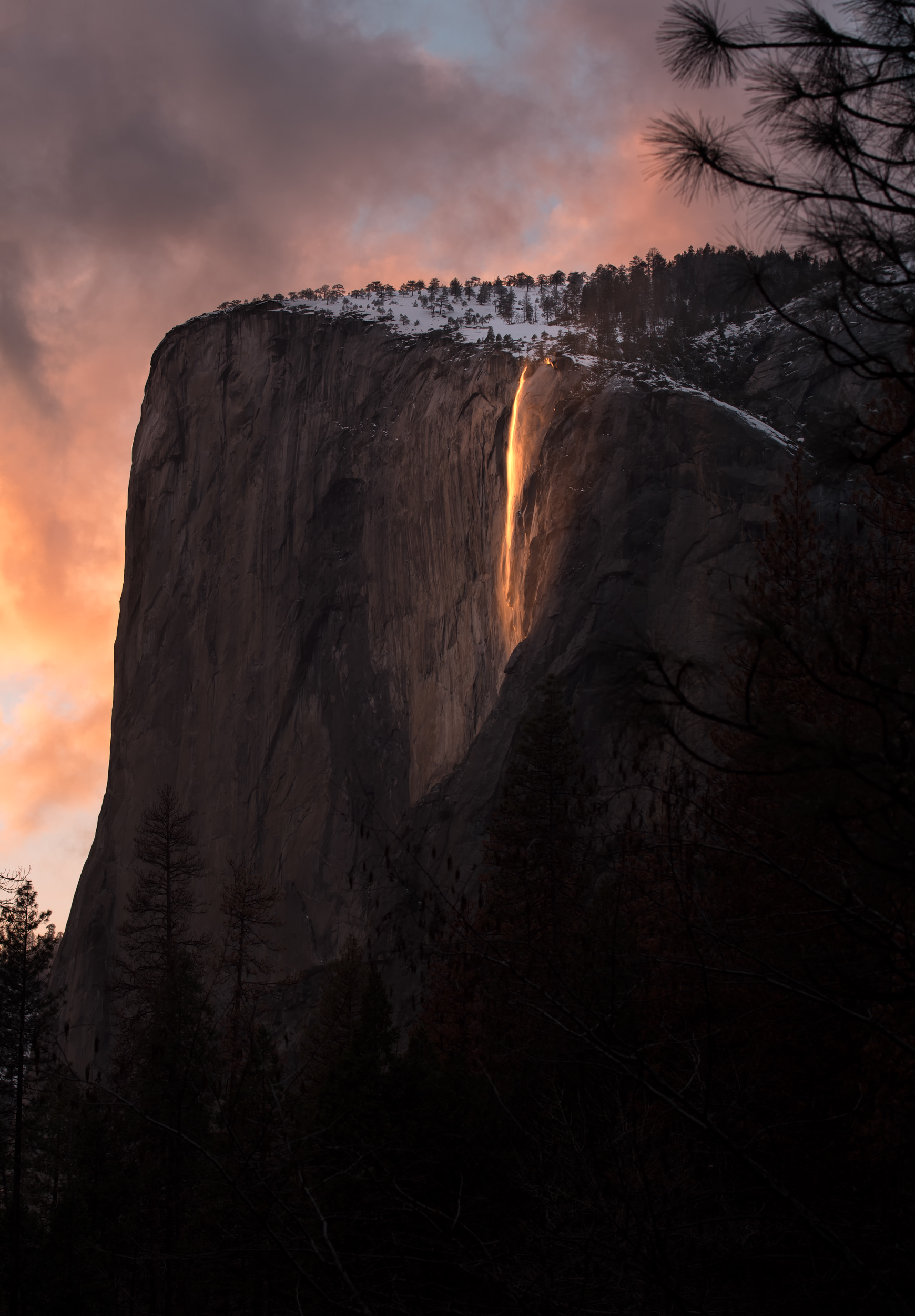 For about ten minutes on maybe fourteen afternoons a year, Horsetail Fall goes the color of a coal fire — snowmelt lit from behind at the one sunset angle that makes water look like something it isn't. None of that depends on you. The snowpack feeding the flow fell weeks earlier and thousands of feet higher; the sky has to stay clear not overhead but along the entire western horizon, sometimes a hundred miles off, or the light never arrives at the right color to begin with — which is a version of an old argument about tennis: that what looks from the stands like one player's singular, earned, dazzling moment is usually just the visible tip of an enormous submerged pile of circumstance. You show up with a camera. The rest got decided somewhere else, earlier, by weather you never met.