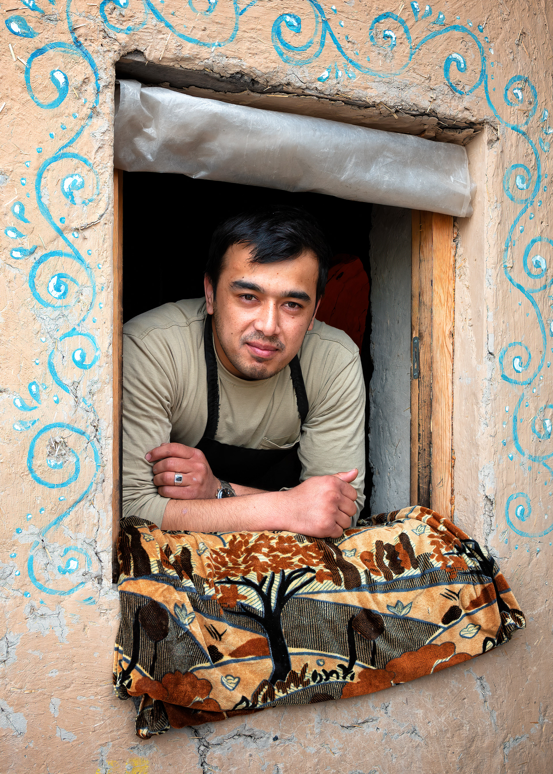 He was working the service window of a bakery — the man in the apron, the tandir glowing behind him just out of frame. I ended up having lunch with the small crew that ran the place. Simple, and genuinely good, the kind of meal that doesn't need a legend or a plaque to be worth remembering.