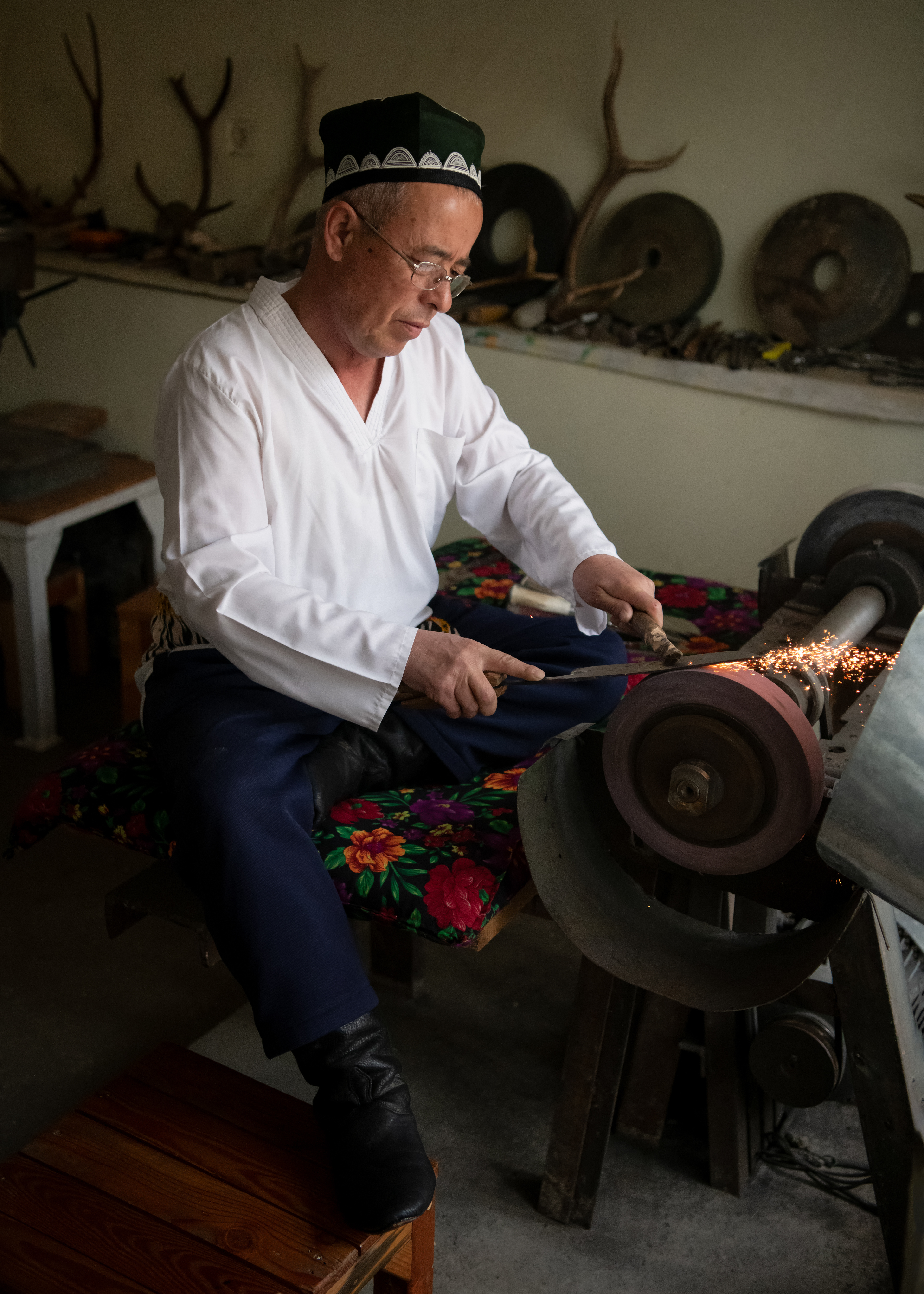 This is Chust, in the Fergana Valley — twelfth-century Chinese travelers on the Silk Road were already logging these blades as the sharpest steel between Damascus and Kashgar. UNESCO added the craft to its intangible heritage list in 2019, the same year this was taken, which is either a coincidence or the closest thing to good timing I've got for this trip. The blade gets quenched in fermented mare's milk brine — nobody fully explained why, and I didn't ask hard enough