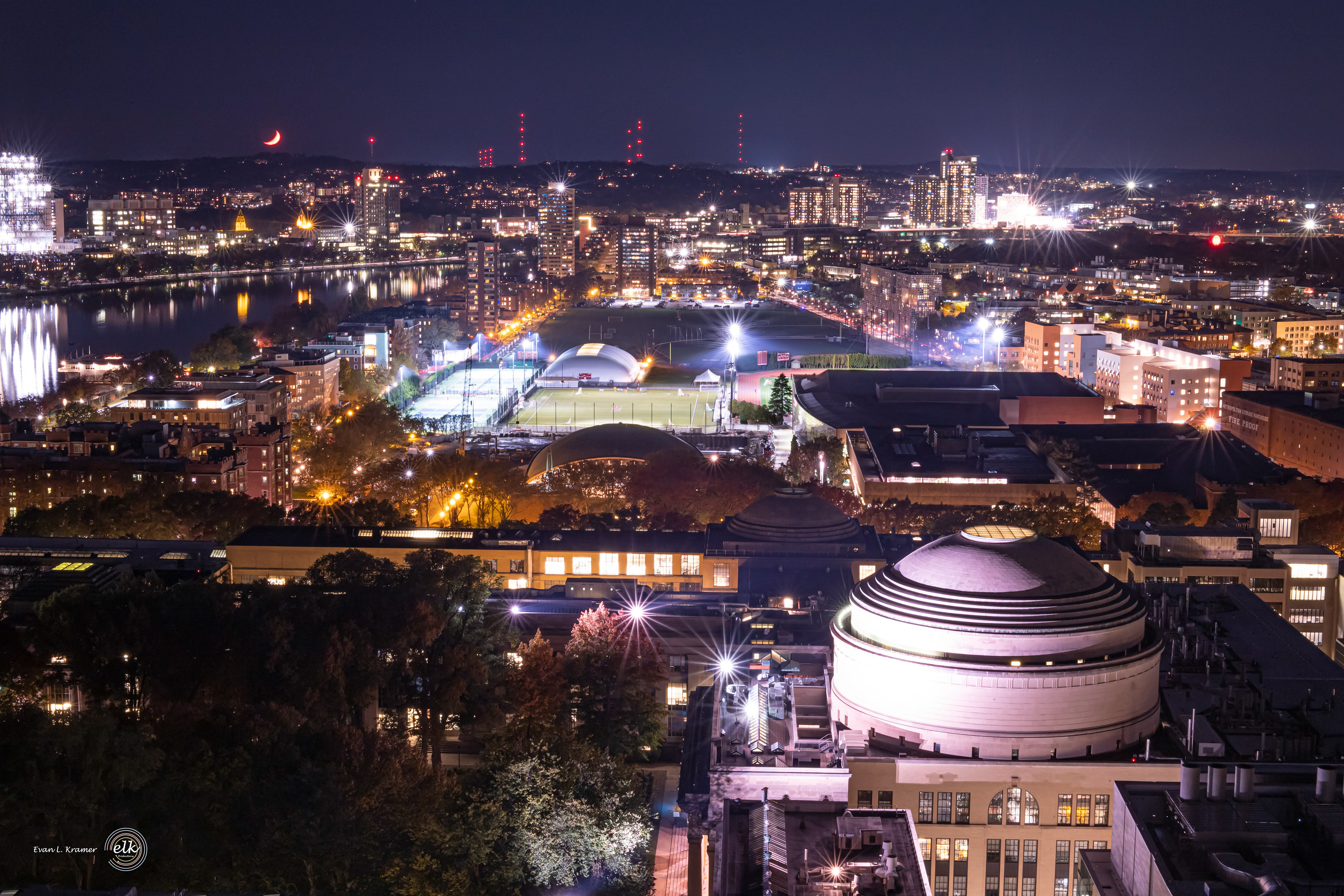 A crescent moon setting behind the horizon. Cambridge, MA.