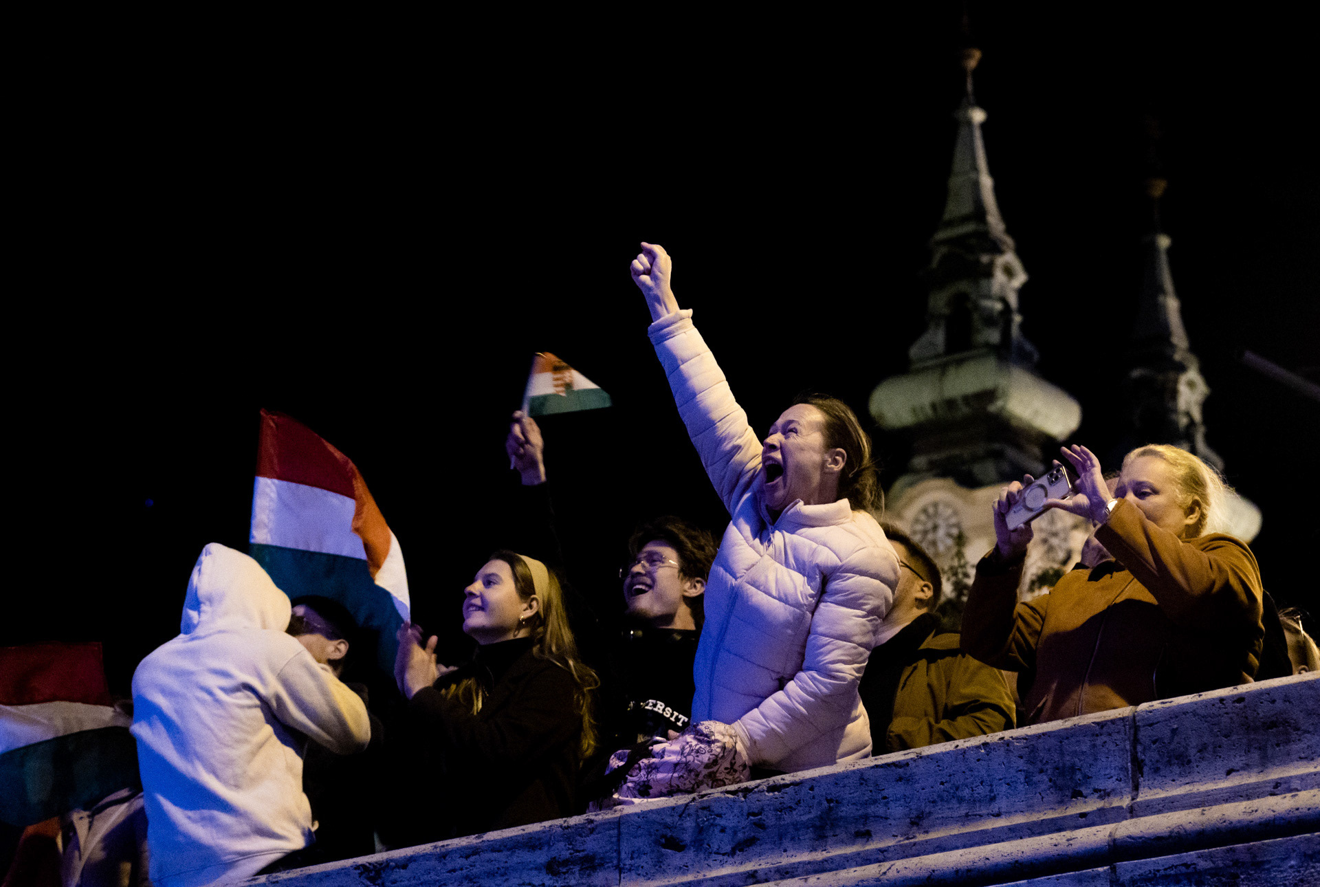 Supporters watch the first live election results few hours before the landslide win of Hungary's newly PM Péter Magyar during the Hungarian election night in Budapest, 12th of April 2026.
