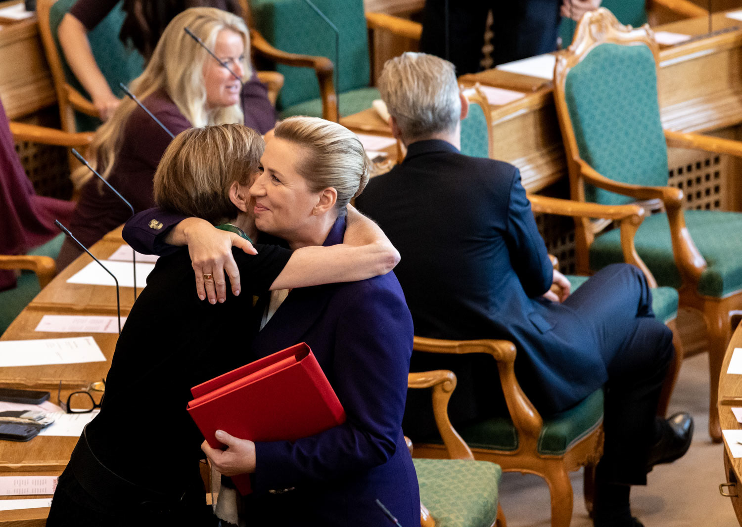 Danish PM Mette Frederiksen greets a parliamentary member on the opening day of the Danish Parliament at Christiansborg Palace, Copenhagen, October 6, 2026 / for NurPhoto Agency