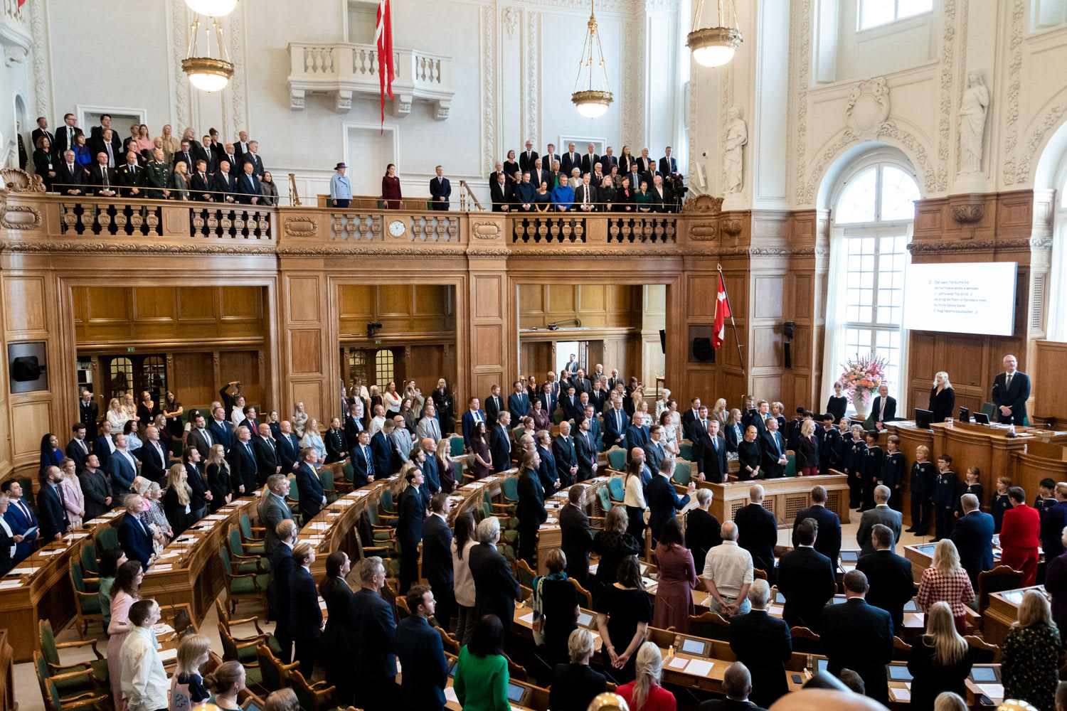 Standing attendees during the singing of Danish national song "There is a lovely land" on the opening day of Folketinget at Christiansborg Palace, Copenhagen, October 6, 2026.  / for NurPhoto Agency
