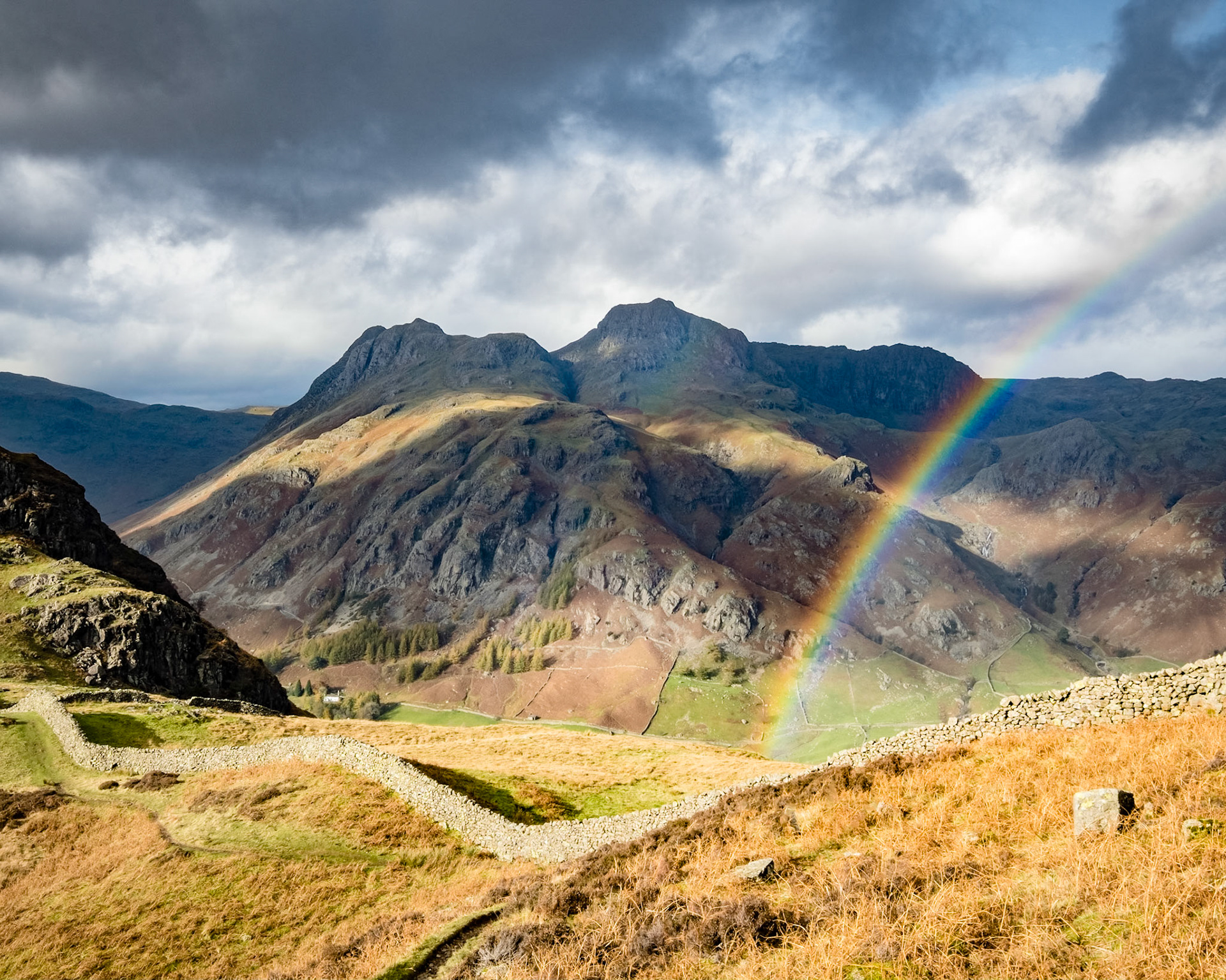 A rainbow splits Ling Moor Fell and the Langdale Pikes