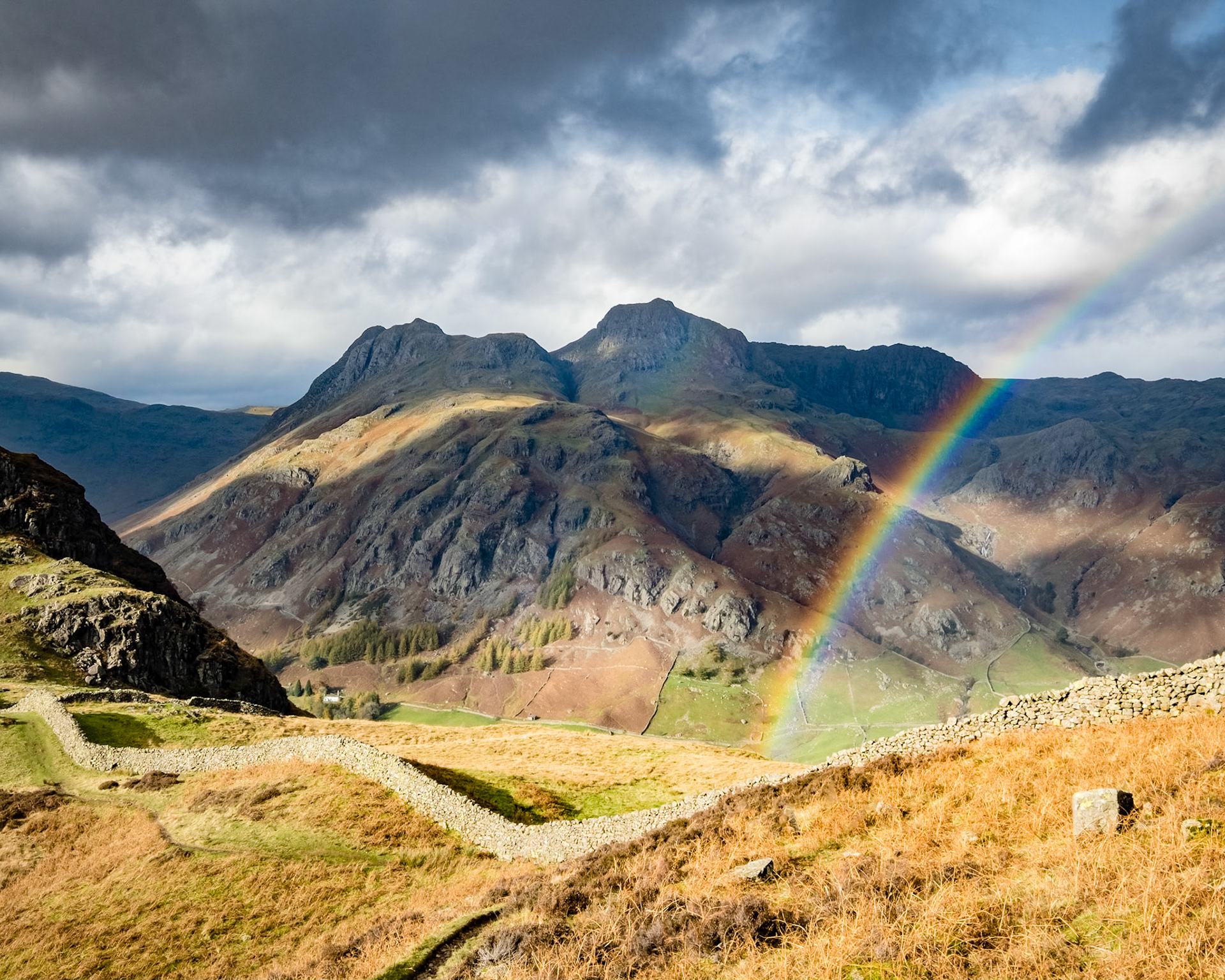 A rainbow splits Ling Moor Fell and the Langdale Pikes