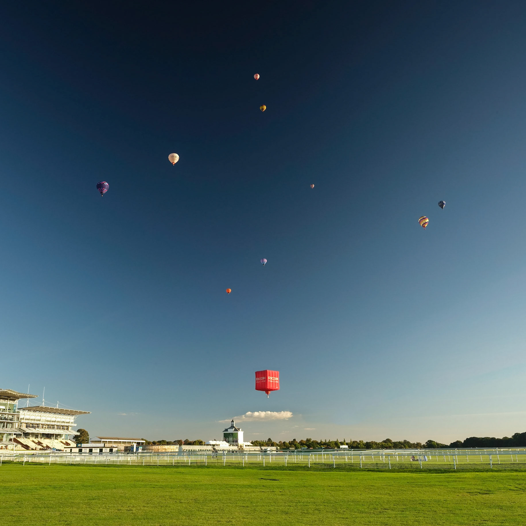 A SOLAR SYSTEM OF BALLOONS OVER YORK RACE COURSE