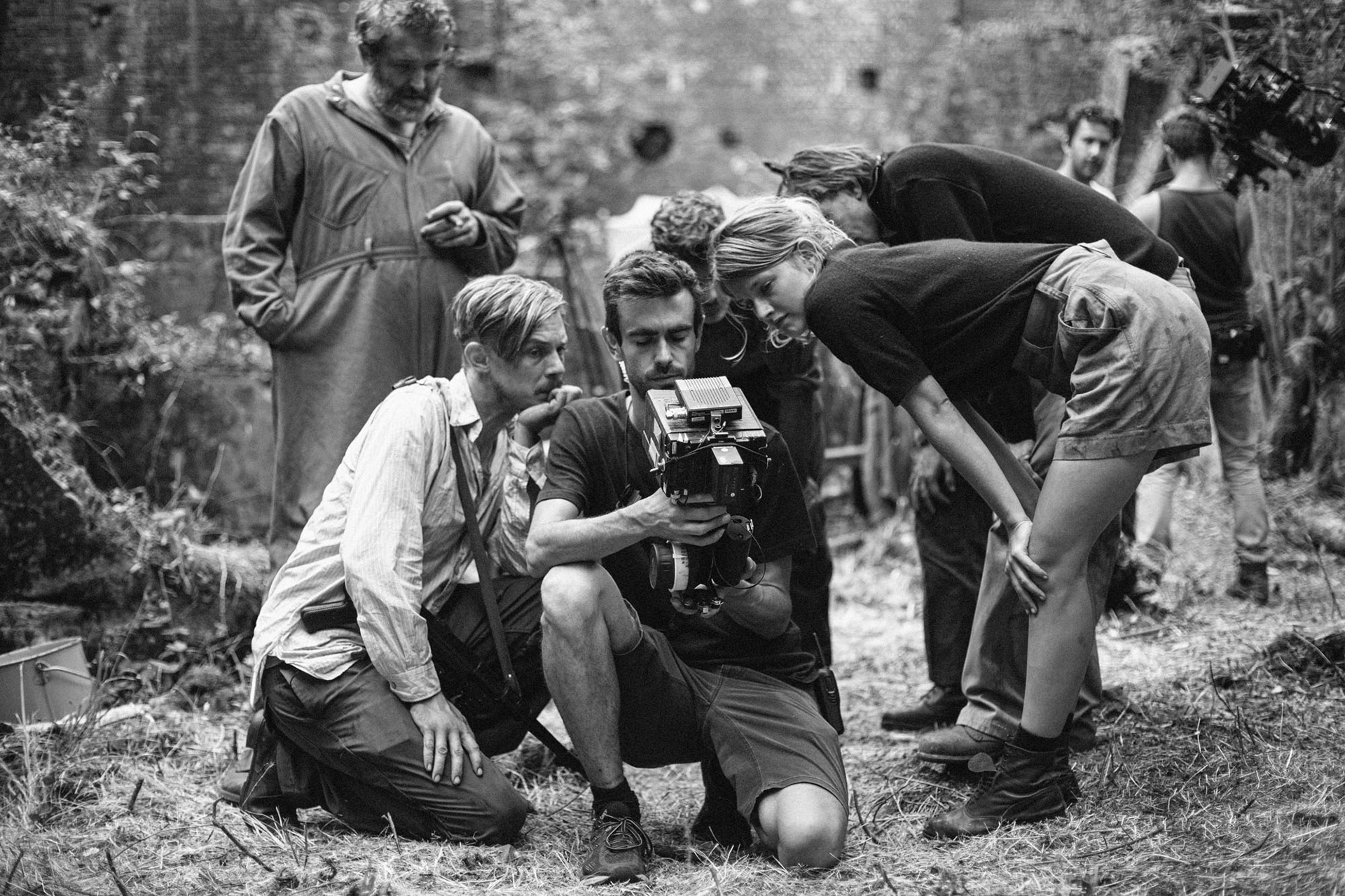 Actors reviewing scene on the screen of the focus puller.