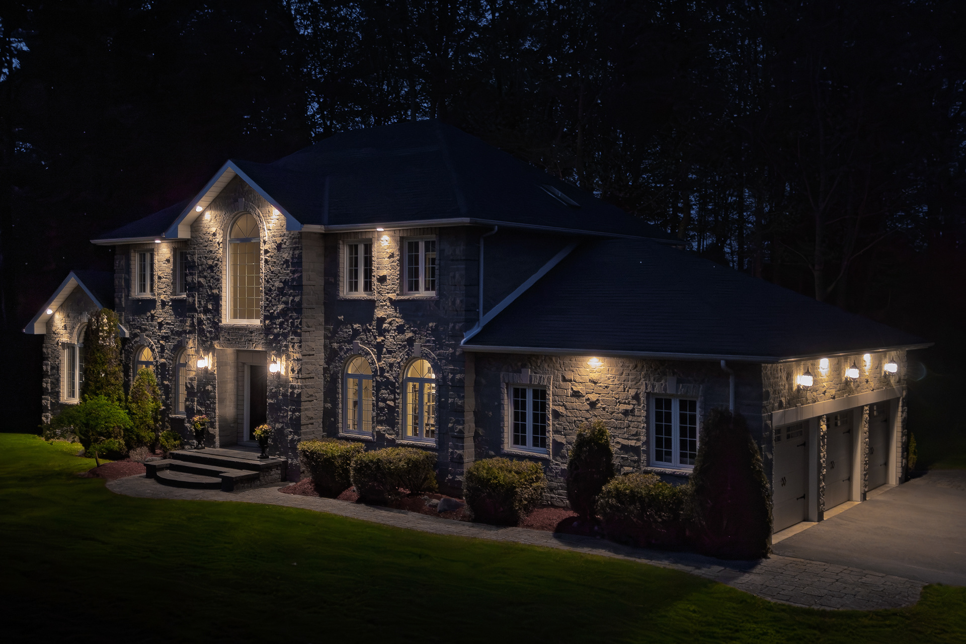 An elevated twilight perspective reveals the property’s scale, architecture, and surrounding landscape.