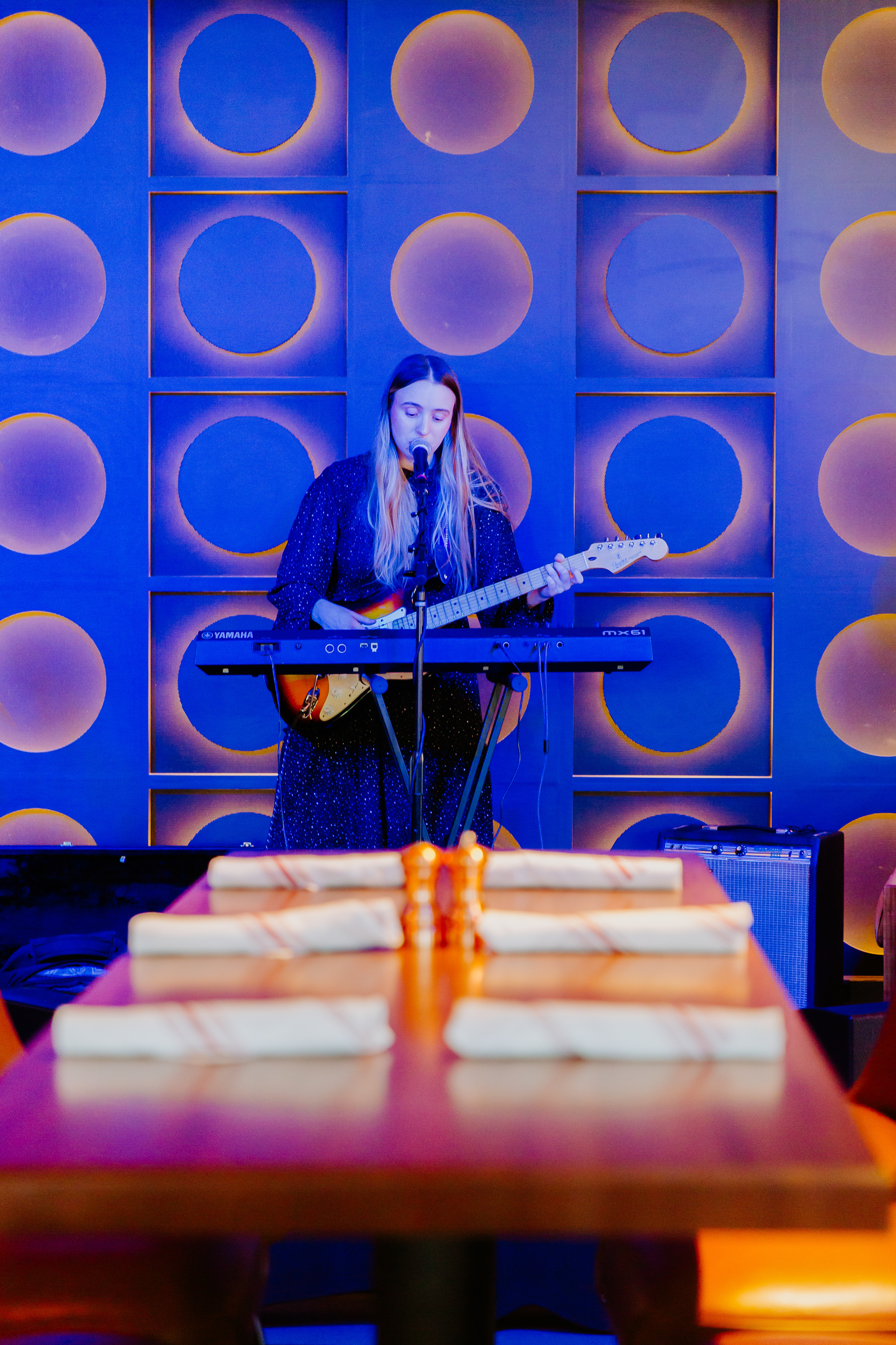 "Speaker" backdrop changes color as musicians perform.