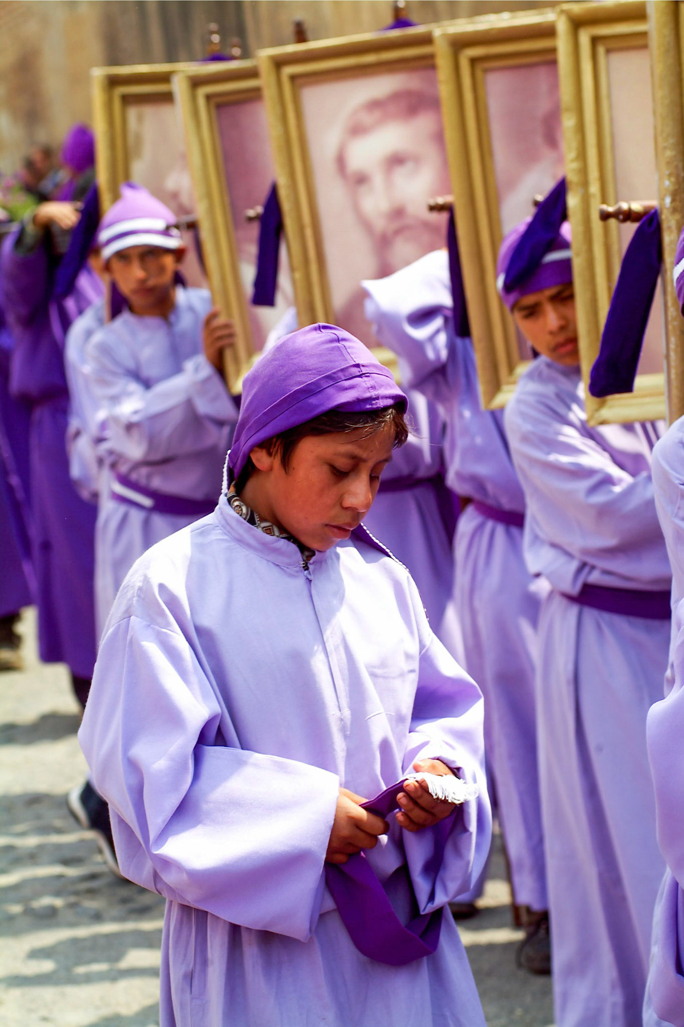 Men dressed in purple robes carry standards  with the pictures of the  Apostols while accompanying Easter Thrusday procession in Antigua Guatemala, 20 miles west Guatemala City, 8th April 2004.  Easter thursday traditional procession carrying Jesus of Nazareth is from San Francisco El Grande a Dominican monastery in the historical city of Antigua.(Photo/Carlos Lopez-Barillas)