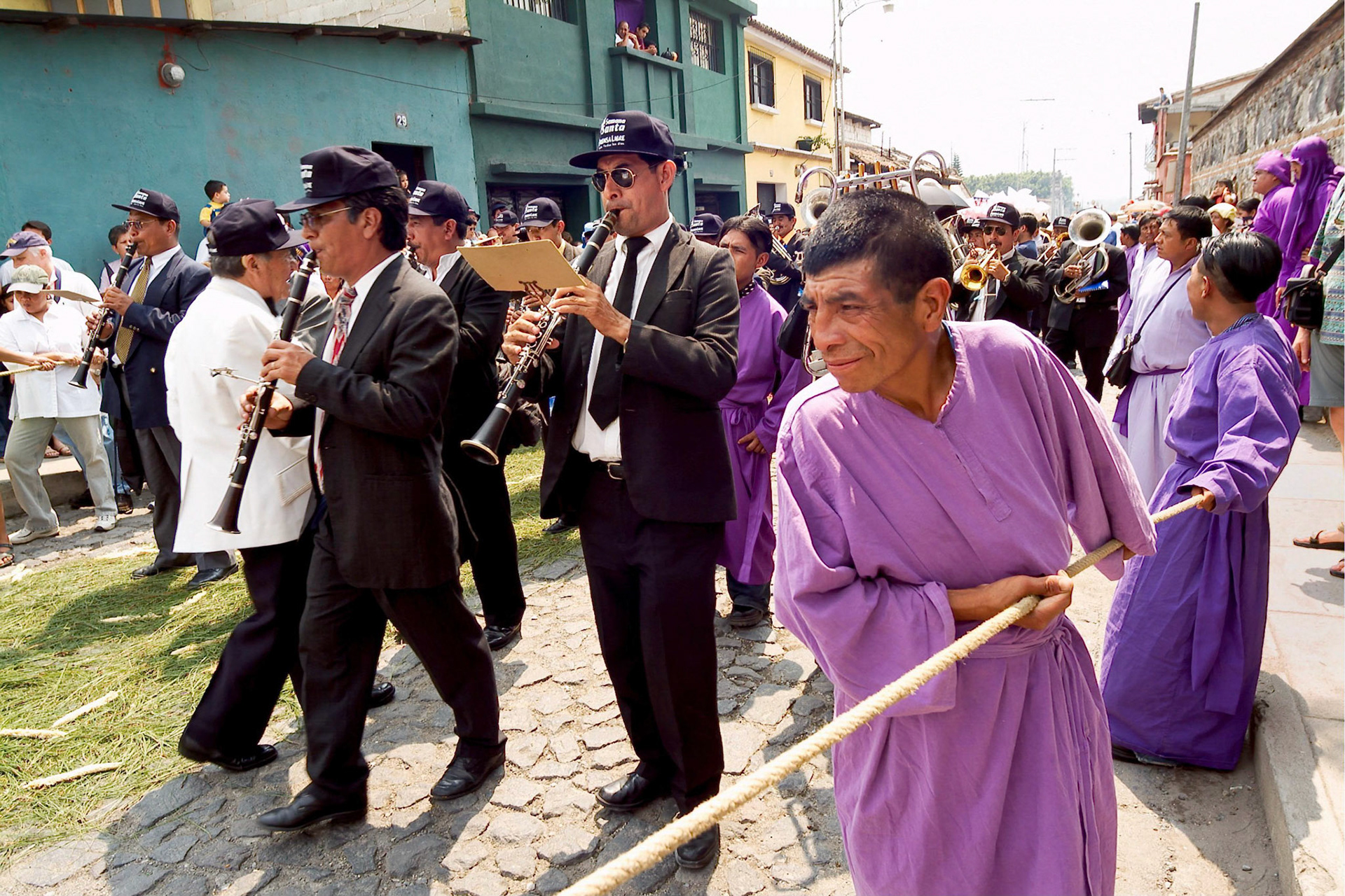 A procession band play funeral marrchs while a procession marshall pulls a security line  while accompanying Easter Thrusday procession in Antigua Guatemala, 20 miles west Guatemala City, 8th April 2004.  Easter thursday traditional procession carrying Jesus of Nazareth is from San Francisco El Grande a Dominican monastery in the historical city of Antigua.(Photo/Carlos Lopez-Barillas)