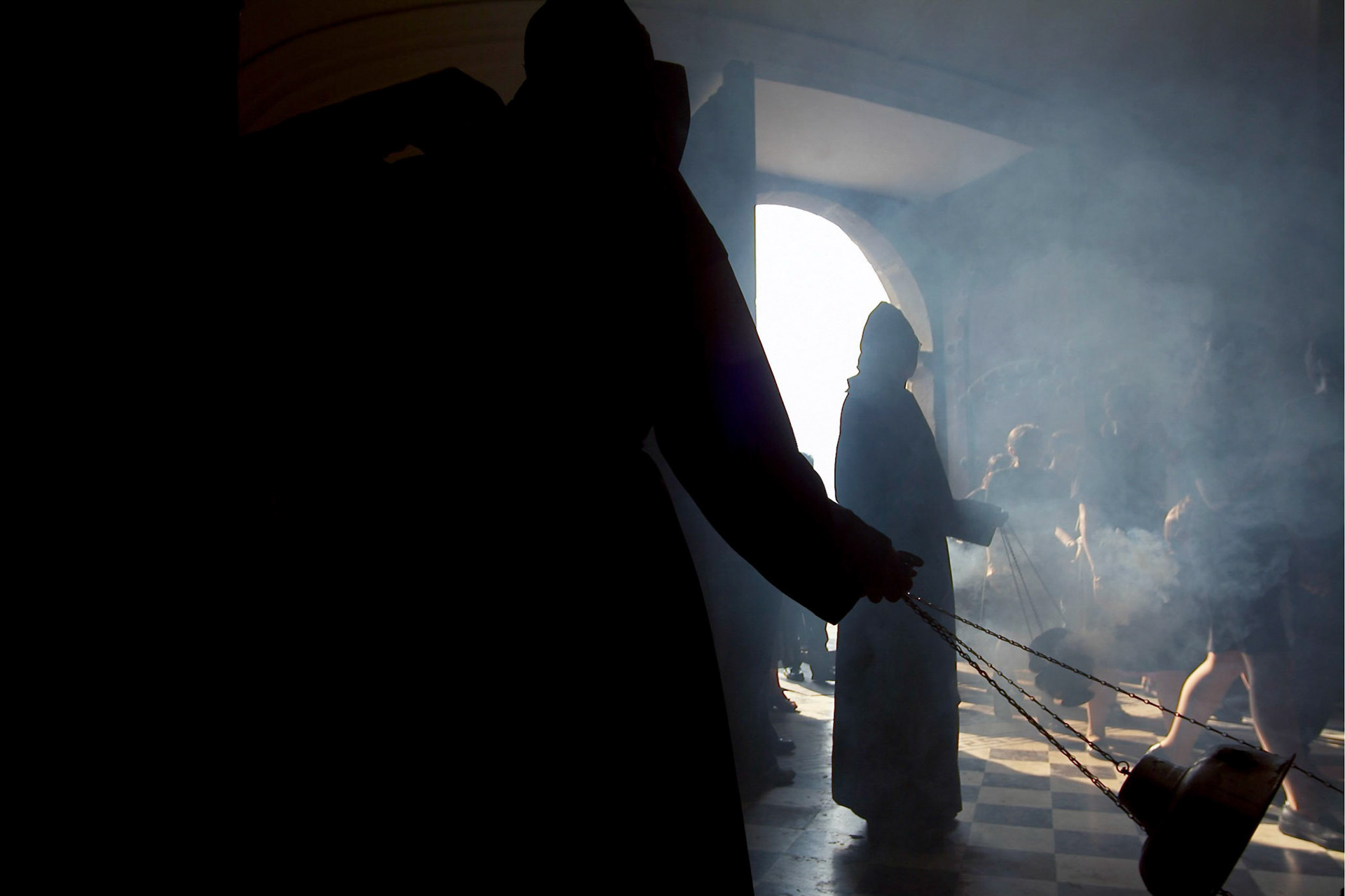 Pallbearers  burn incensce inside Escuela de Cristo church before Easter Saturday procession in Antigua Guatemala, 20 miles west Guatemala City, 10th April 2004.(Photo/Carlos Lopez-Barillas)
