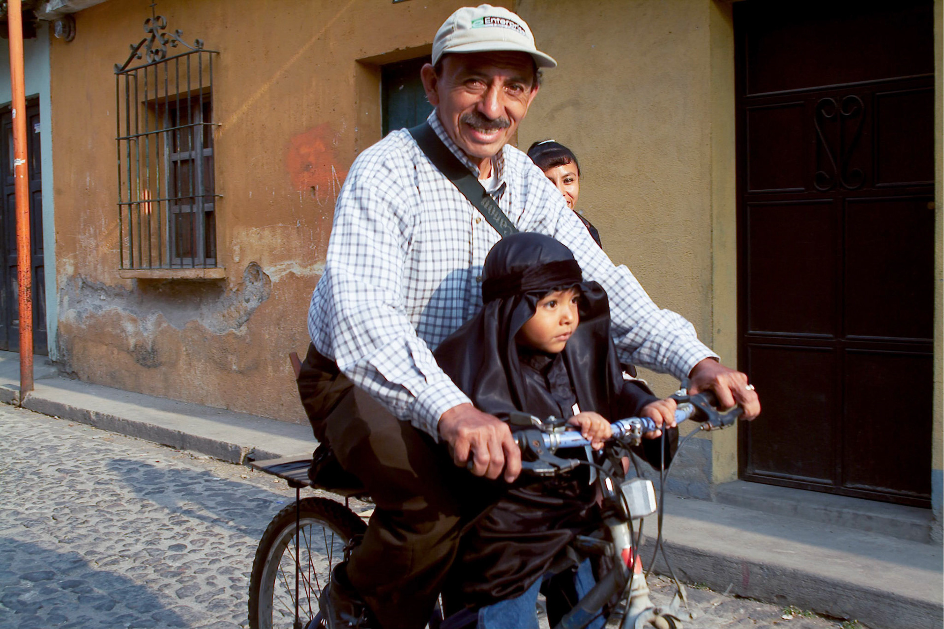 A youngster dresssed up in traditional Easter Saturday black robes accompanies relatives to Easter Saturday procession in Antigua Guatemala, 20 miles west Guatemala City, 10th April 2004.(Photo/Carlos Lopez-Barillas)