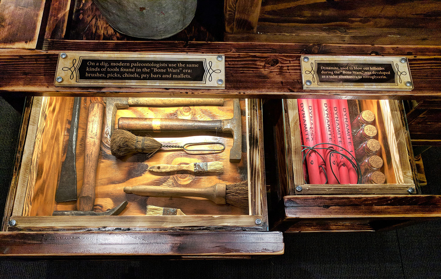This artifact cabinet- one of several-  helps to flesh out the story. Locking drawers, protected by acrylic panels, close for transport. Like every cabinet in this section of the exhibition, it’s designed with pallet jack slots that are part of the aesthetic. My SketchUp designs were brought to life by the highly skilled Stage Nine build team, who even fabricated a branding iron to mark the “crates.”
