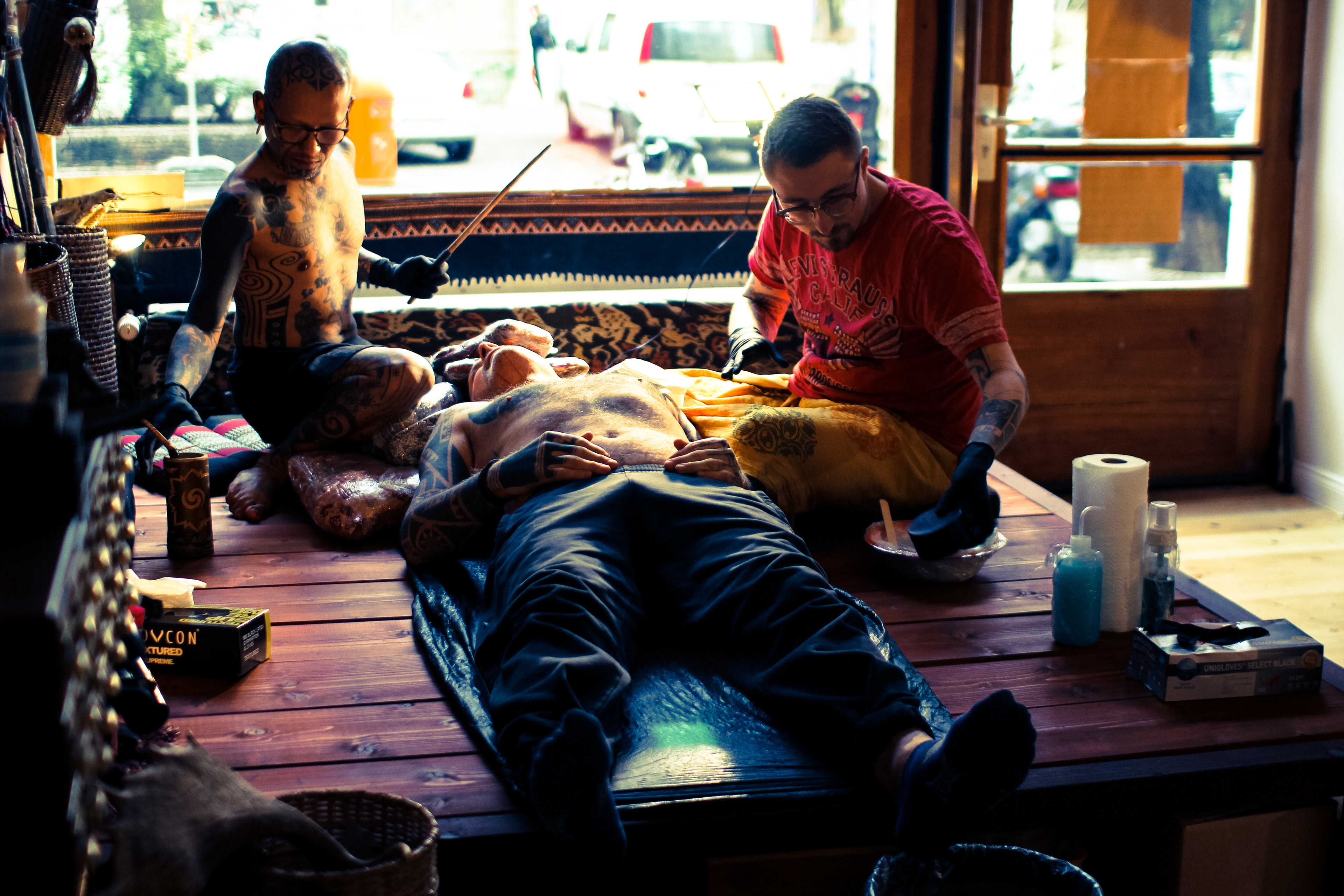 Tattoo artist Durga of Durga Tattoo working on Mentawai Ti'ti Mentawai tattoo using the traditional hand tapping instruments