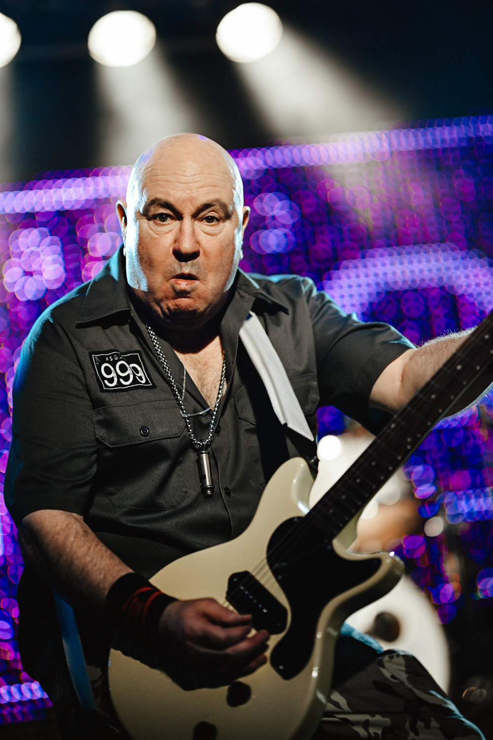 Nick Cash playing the guitar on stage with his English punk rock band 999 at Epic Studios Norwich on 8th December 2019