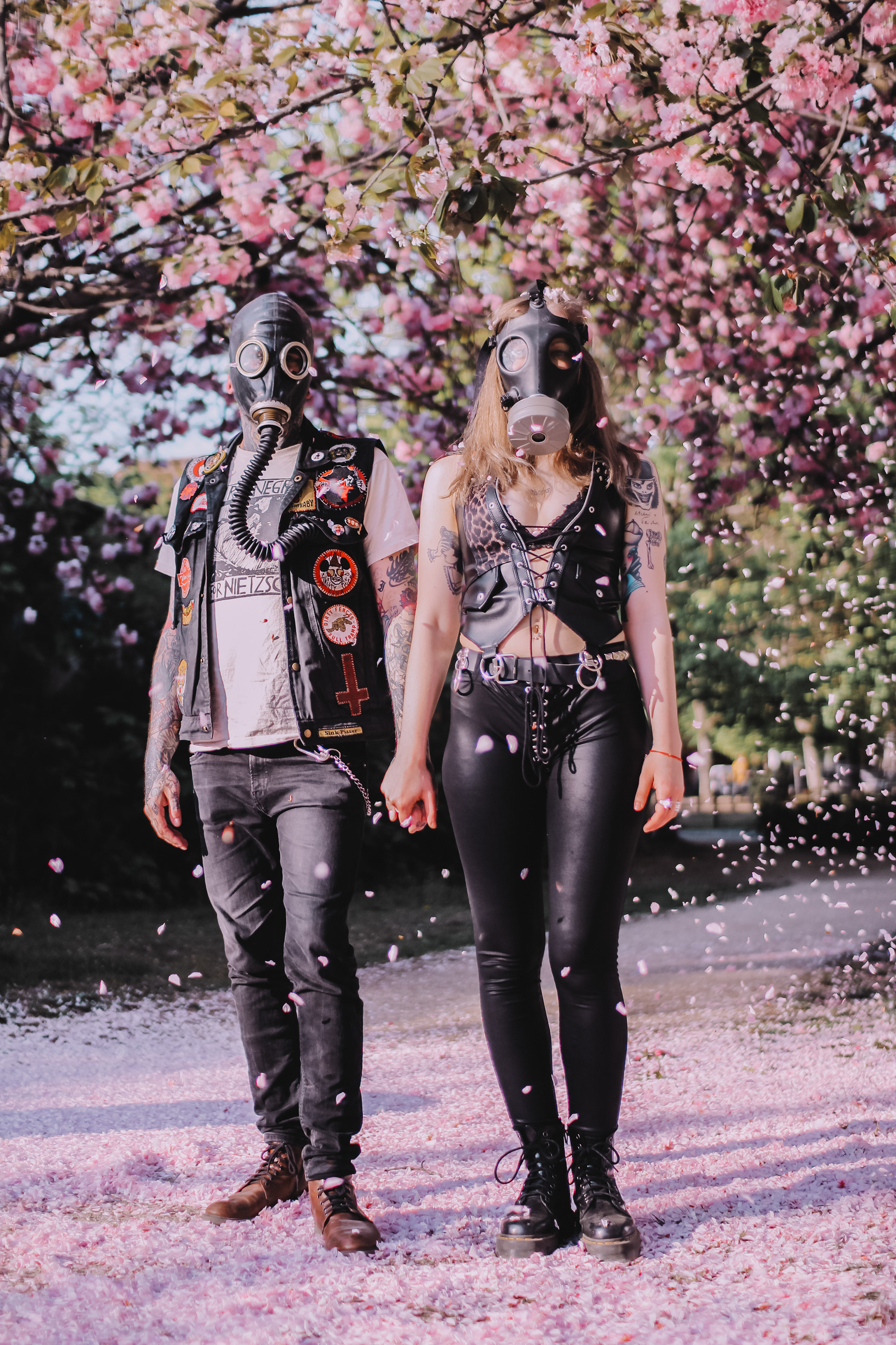 Pandemic Love Affair covid post apocalyptic series shot of a couple in love wearing gas masks under a cherry blossom tree