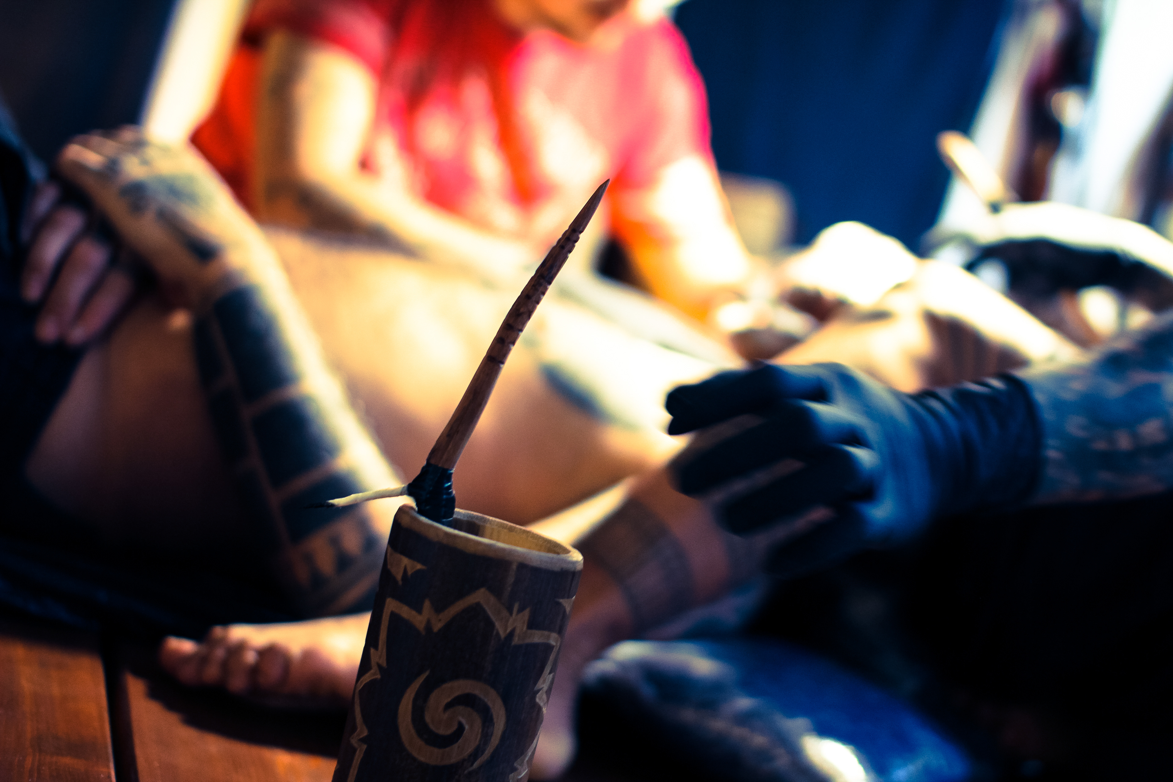 Tattoo artist Durga of Durga Tattoo working on Mentawai Ti'ti Mentawai tattoo using the traditional hand tapping instruments