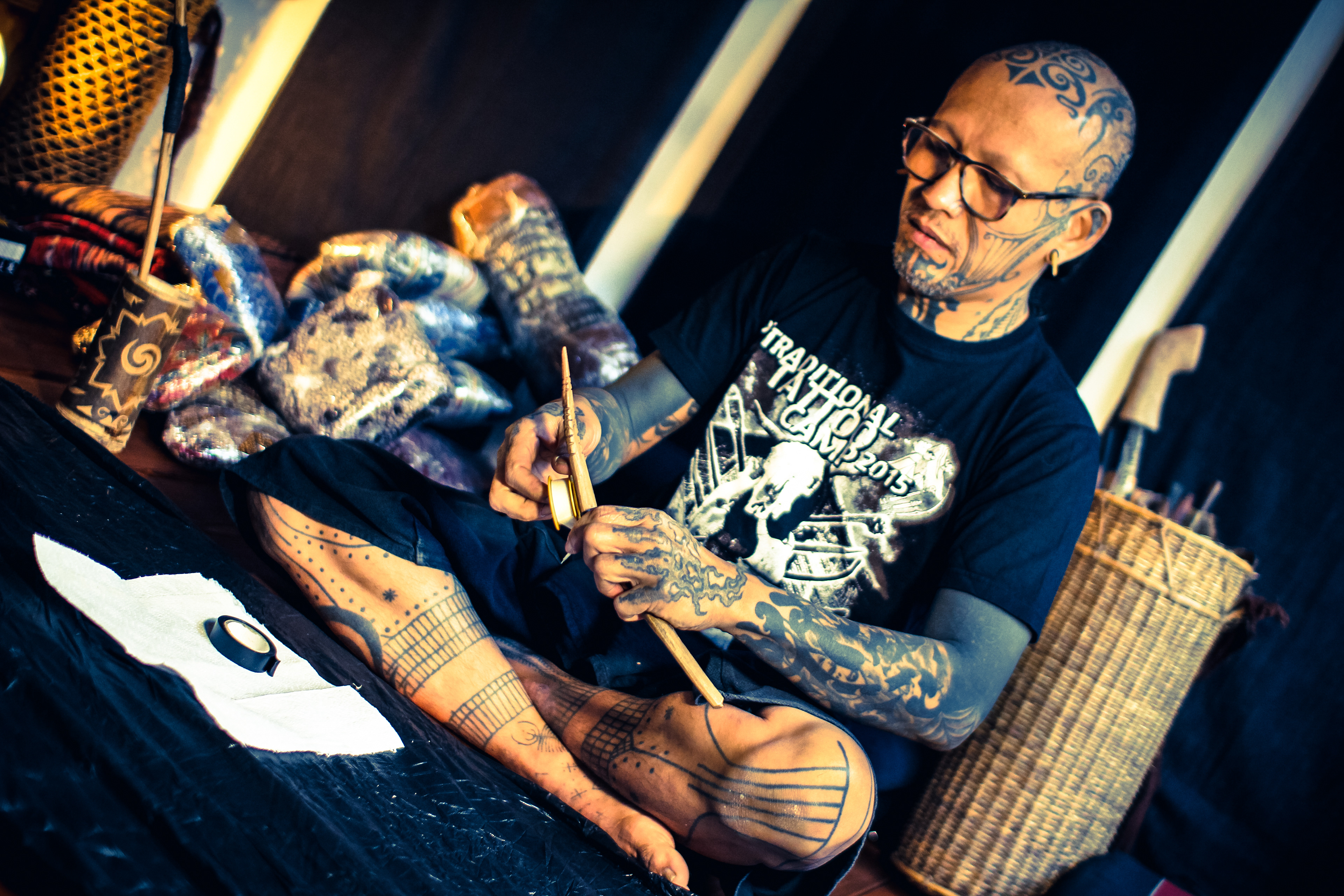 Tattoo artist Durga of Durga Tattoo working on Mentawai Ti'ti Mentawai tattoo using the traditional hand tapping instruments