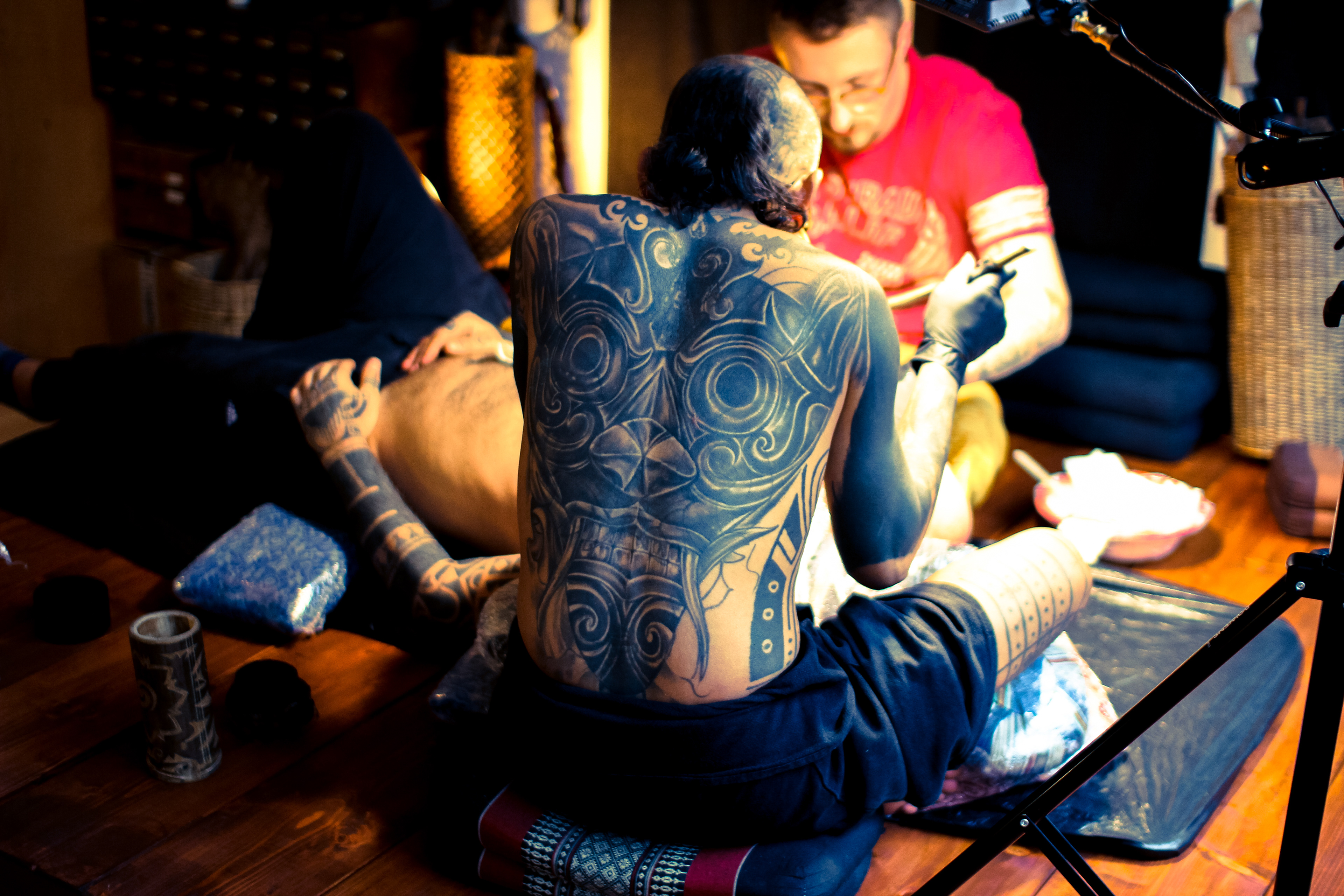 Tattoo artist Durga of Durga Tattoo working on Mentawai Ti'ti Mentawai tattoo using the traditional hand tapping instruments