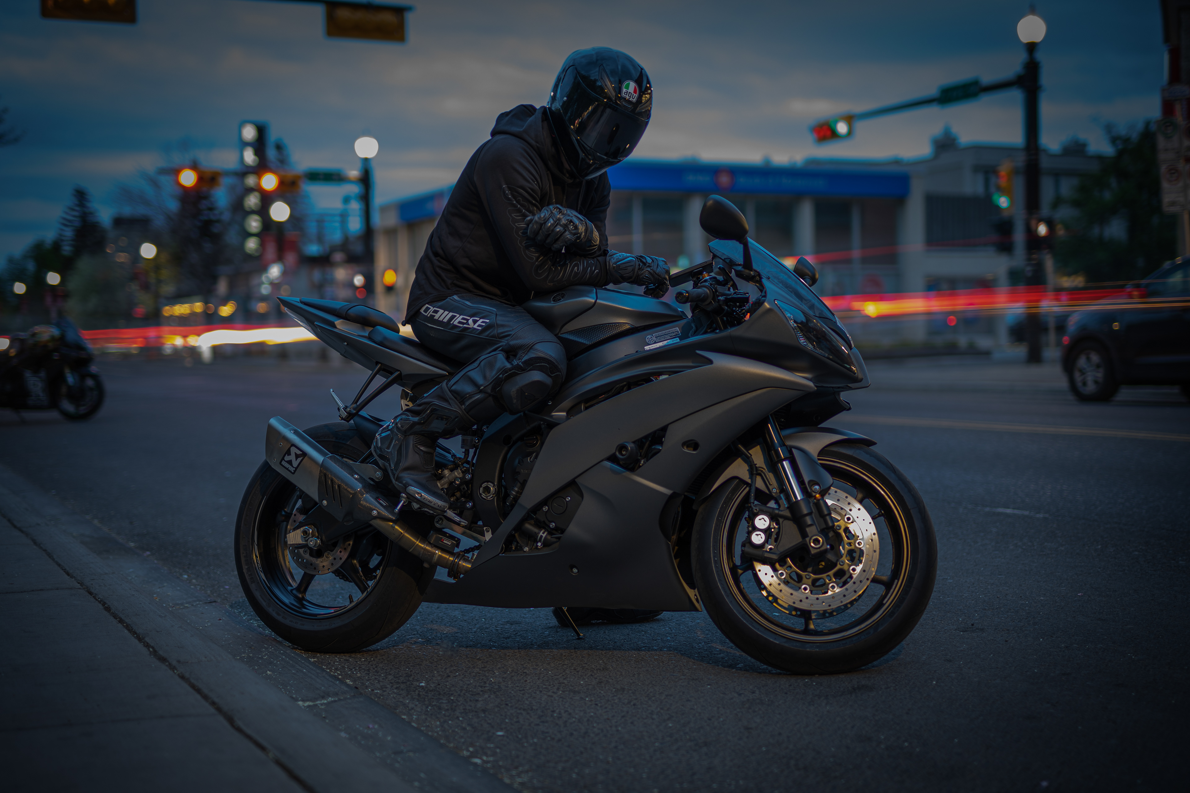Calgary motorcycle photography by Black Rev Studio—rider wearing AGV helmet and Dainese gear on a Yamaha sportbike during an urban night shoot.