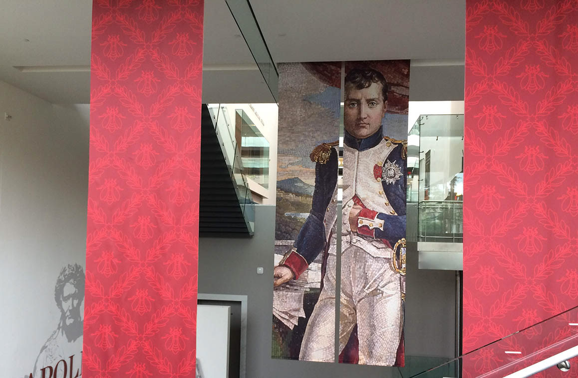 Installation view of fabric banners at exhibition entrance.