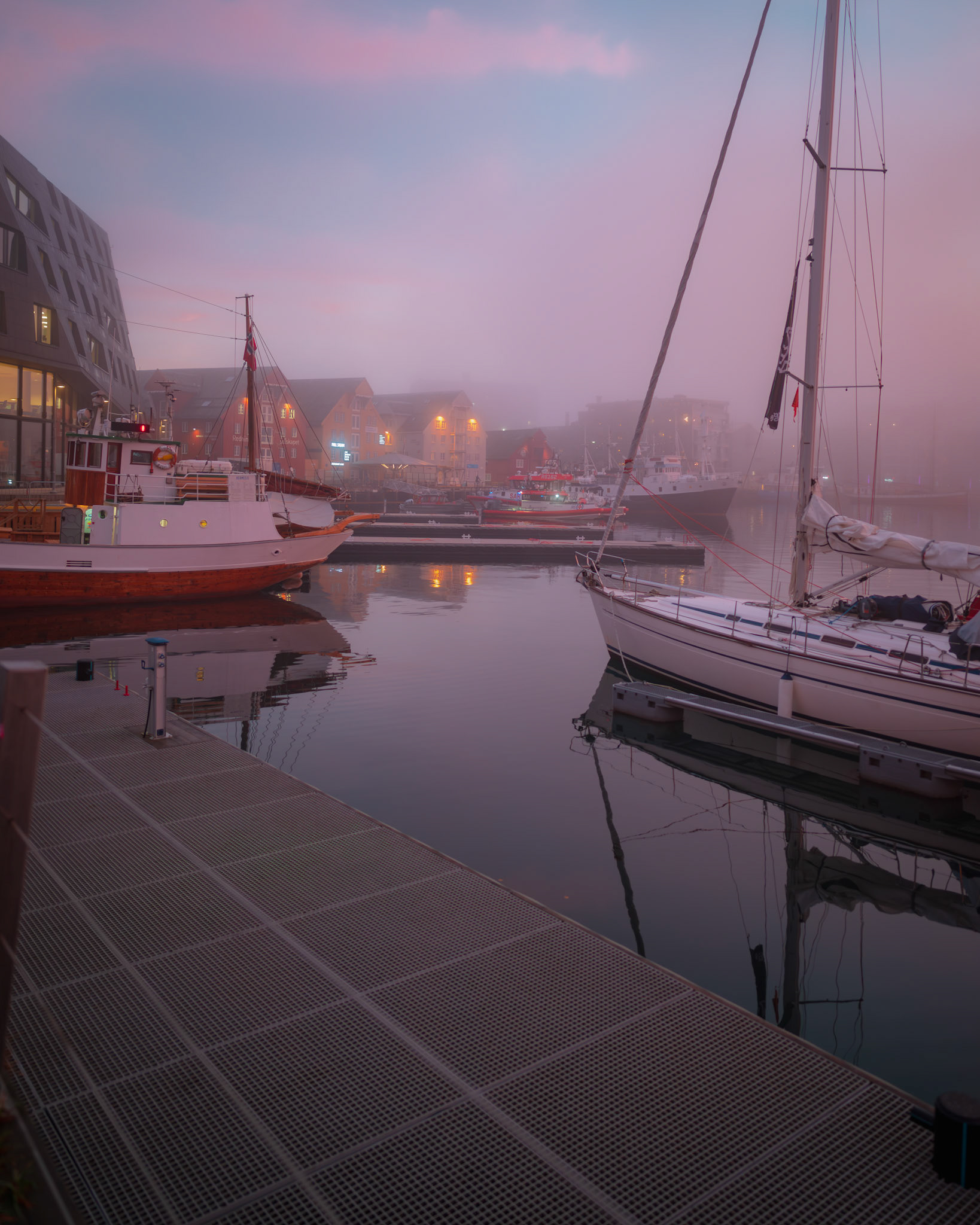 Foggy harbour morning. Dreamy pink dawn over Tromsø Harbour