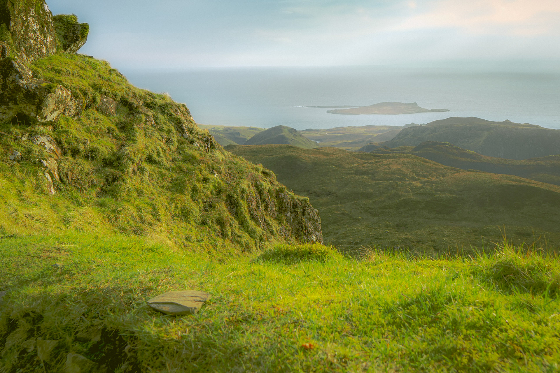 The first light touches the cliffs, spilling gold over the rugged hills and the endless sea beyond. A quiet moment where the land breathes, the sky shifts, and the morning unfolds over the Isle of Skye—a place where time lingers and the horizon feels infinite.