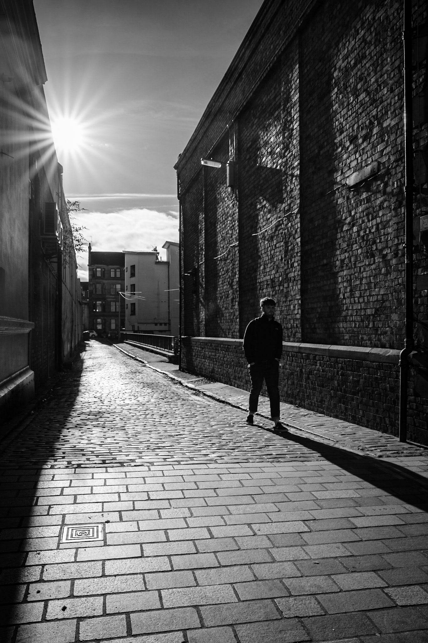Silhouette of a young student in long winding lane.