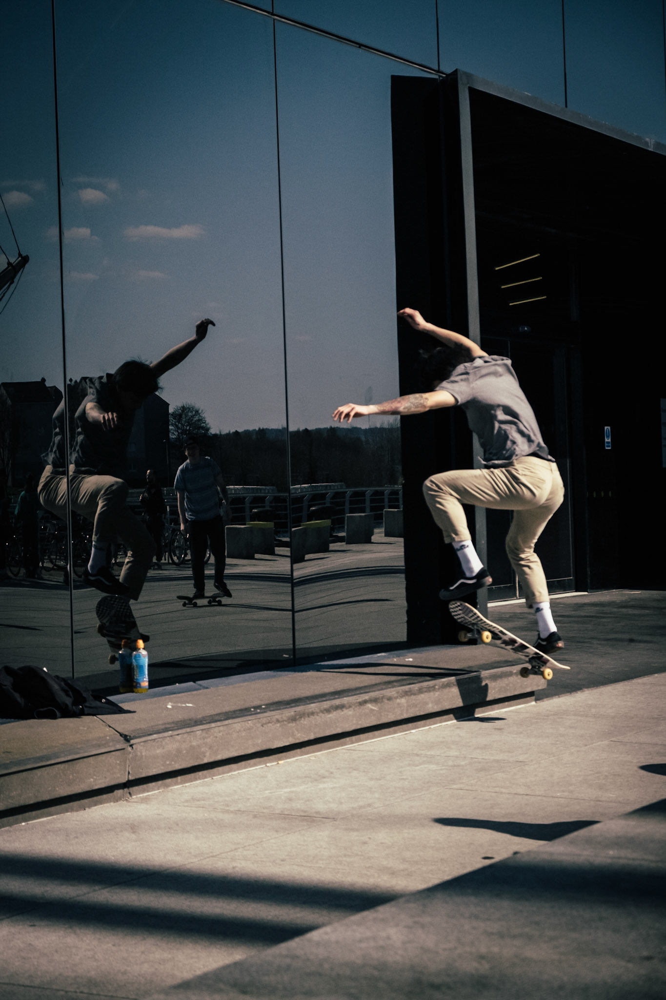 Skateboard moment through the reflection.