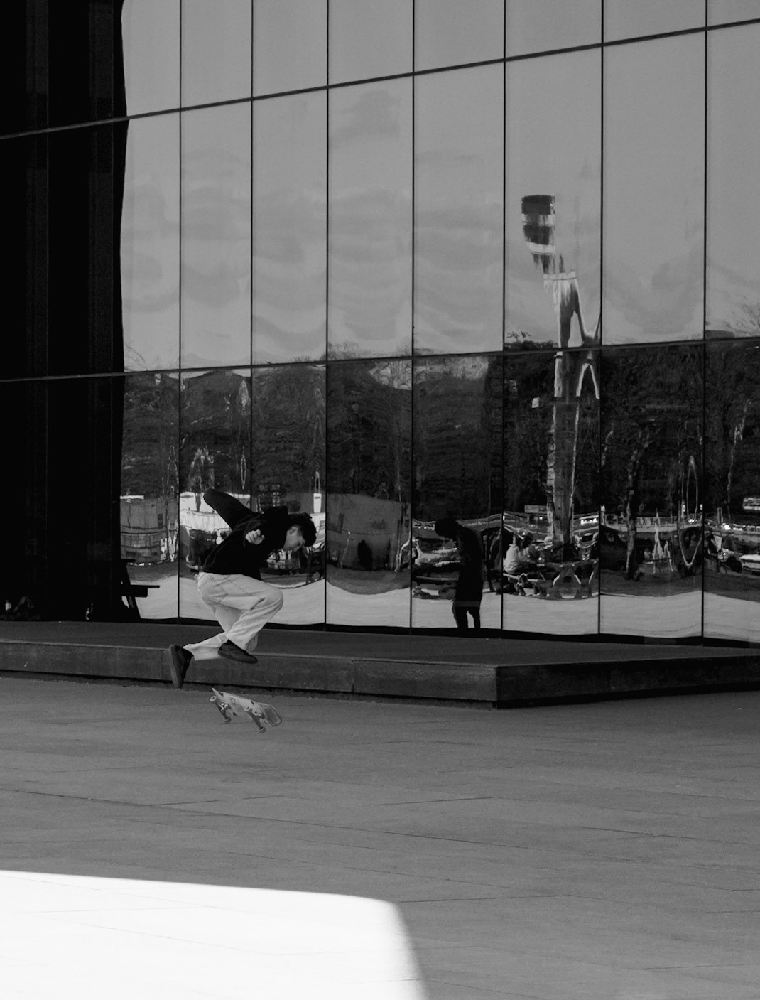 Skateboarder jumping high with the trick.