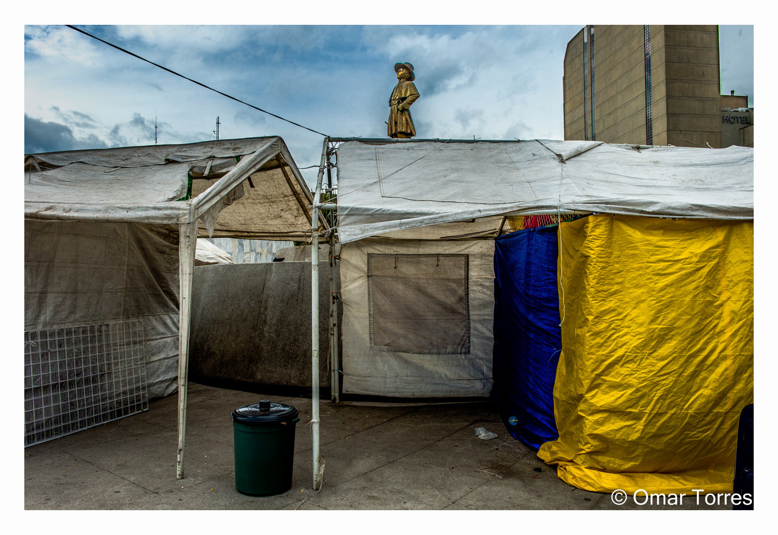 Statue Above Tents