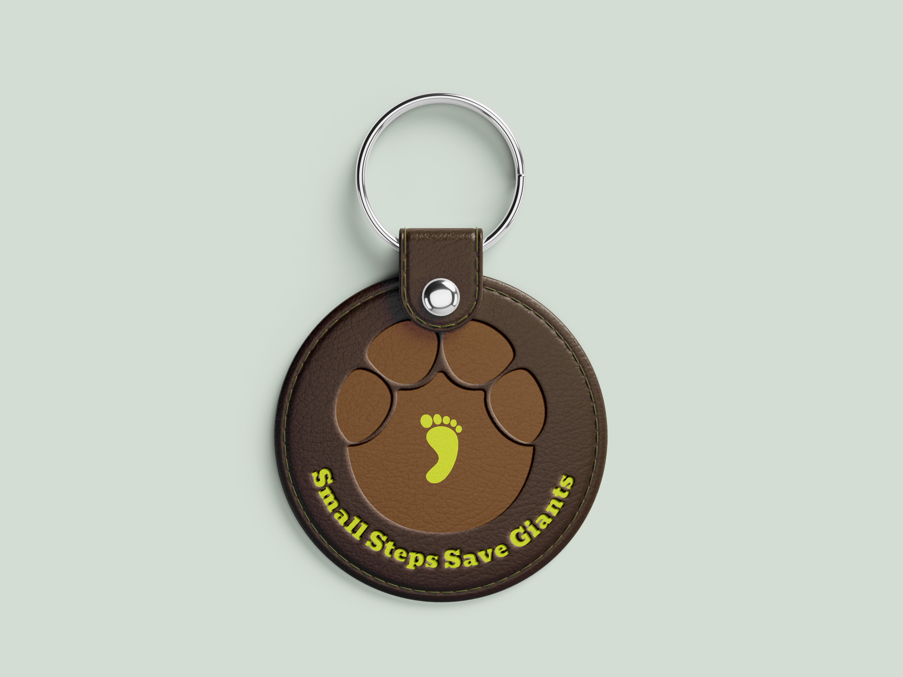 A keychain with Small Steps Save Giants' logo and slogan printed on it.