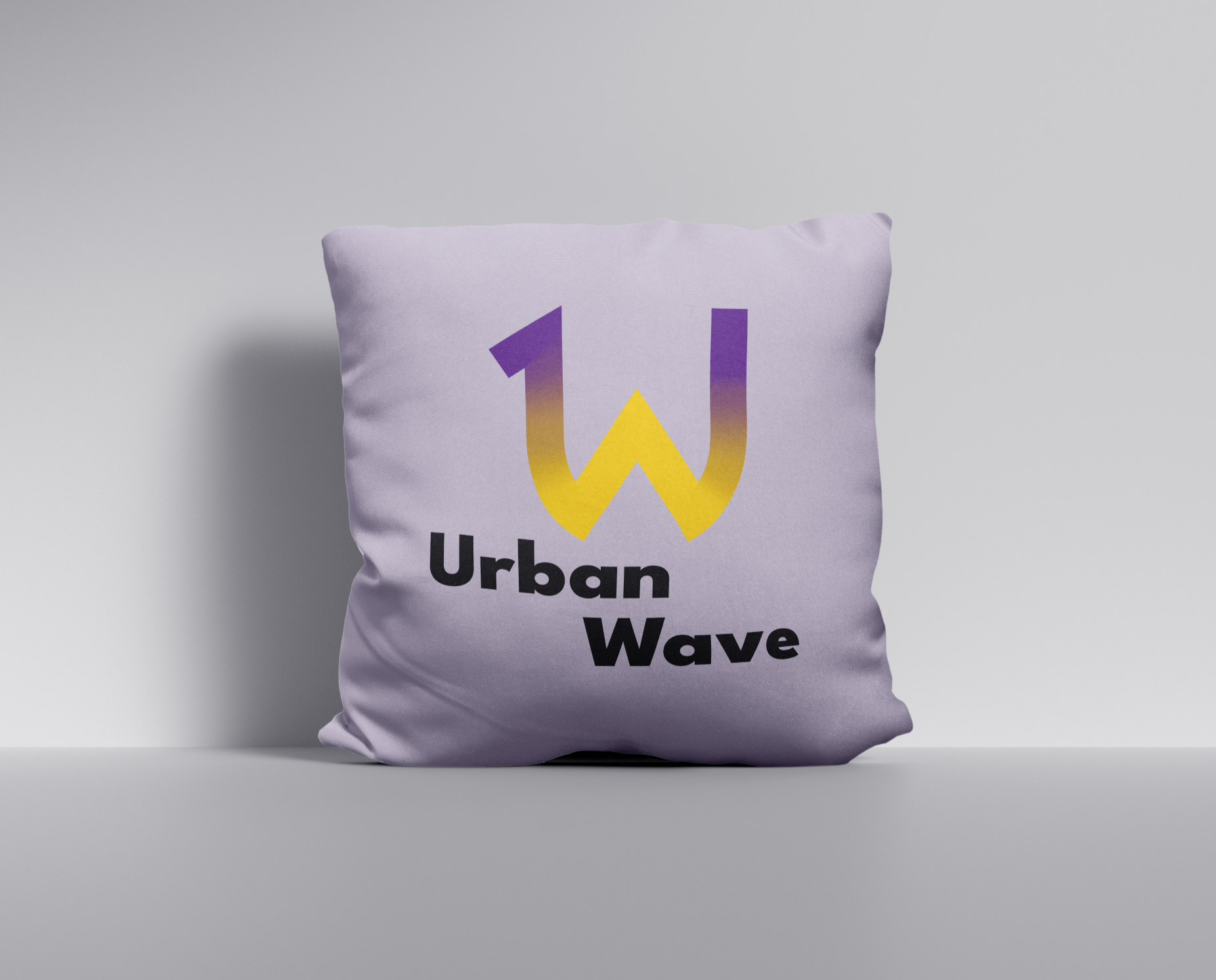 A mockup of Urban Wave's logo printed on a pillow.