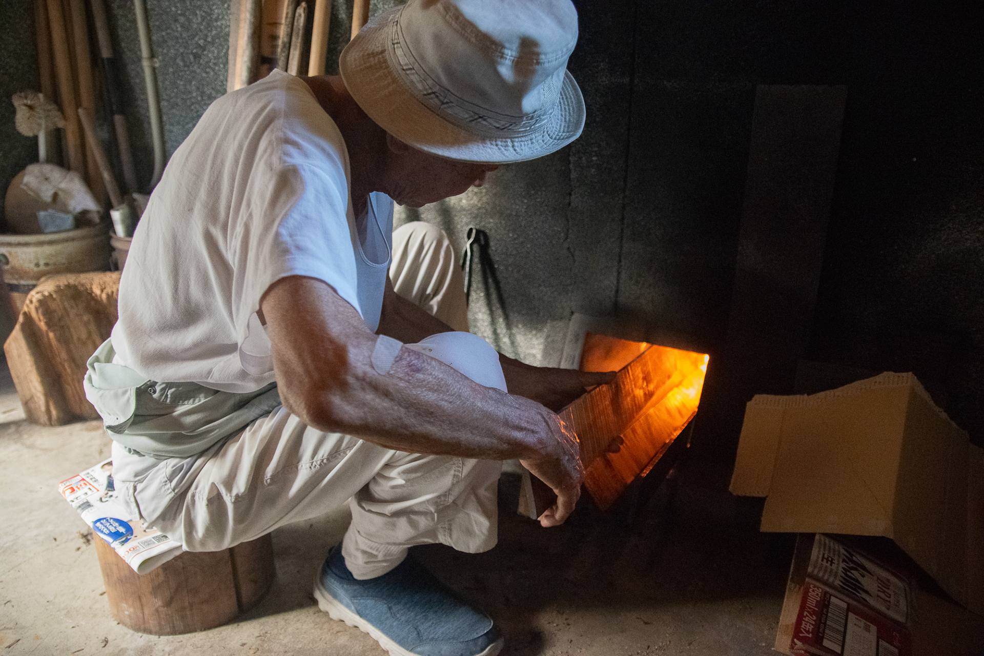 My grandfather is tending the bath fire.