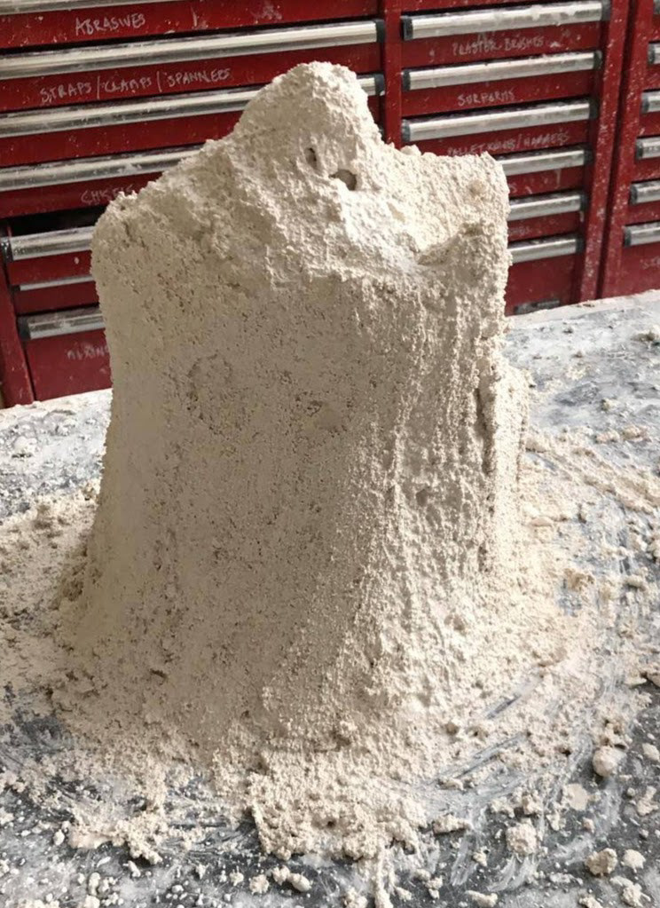 Assembling the plaster mold, building in layers with increased material coarseness and a final layer of chicken wire for structure.